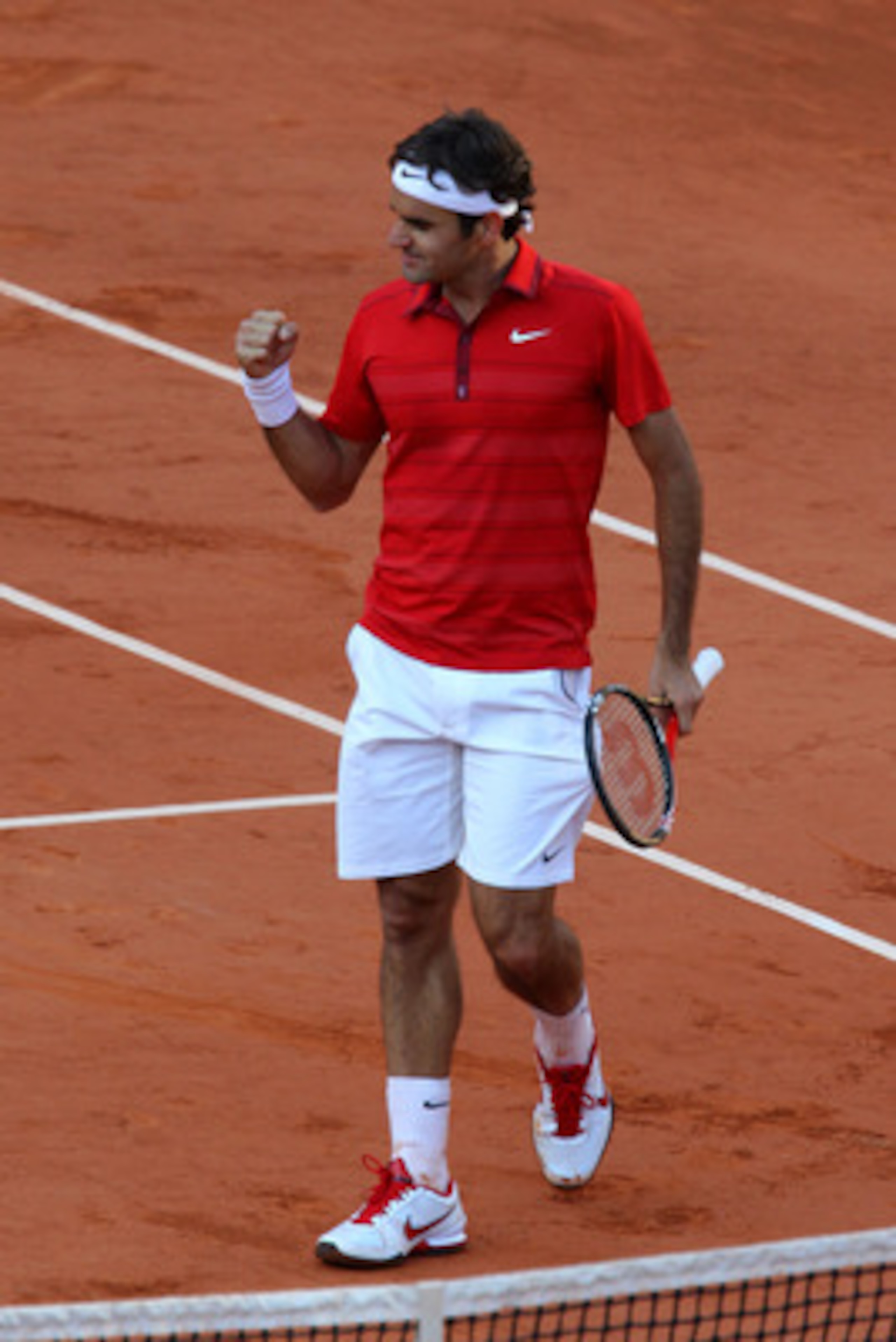 PARIS, FRANCE - MAY 31:  Roger Federer of Switzerland celebrates matchpoint during the men's singles quarterfinal match between Gael Monfils of France and Roger Federer of Switzerland on day ten of the French Open at Roland Garros on May 31, 2011 in Paris