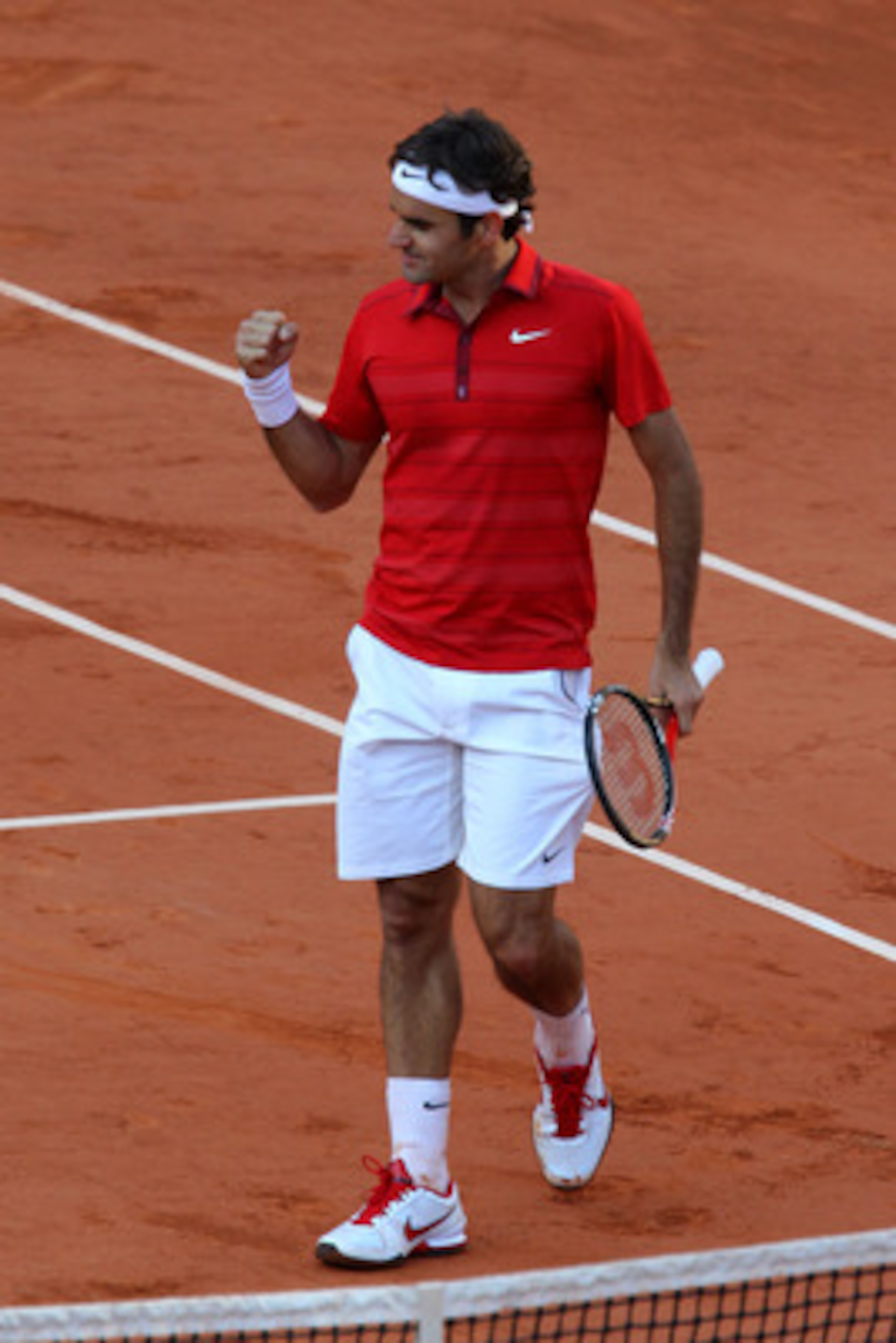 PARIS, FRANCE - MAY 31:  Roger Federer of Switzerland celebrates matchpoint during the men's singles quarterfinal match between Gael Monfils of France and Roger Federer of Switzerland on day ten of the French Open at Roland Garros on May 31, 2011 in Paris