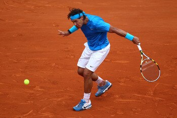 PARIS, FRANCE - MAY 30:  Rafael Nadal of Spain hits a backhand during the men's singles round four match between Rafael Nadal of Spain and Ivan Lubicic of Croatia on day nine of the French Open at Roland Garros on May 30, 2011 in Paris, France.  (Photo by