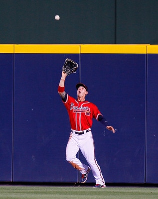 ATLANTA, GA - MAY 29:  Jordan Schafer #1 of the Atlanta Braves catches a deep fly ball hit by Scott Rolen #27 of the Cincinnati Reds in the fourth inning at Turner Field on May 29, 2011 in Atlanta, Georgia.  (Photo by Kevin C. Cox/Getty Images)