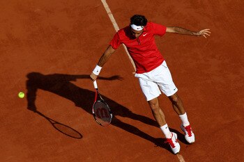 PARIS, FRANCE - MAY 31:  Roger Federer of Switzerland hits a backhand during the men's singles quarterfinal match between Gael Monfils of France and Roger Federer of Switzerland on day ten of the French Open at Roland Garros on May 31, 2011 in Paris, Fran