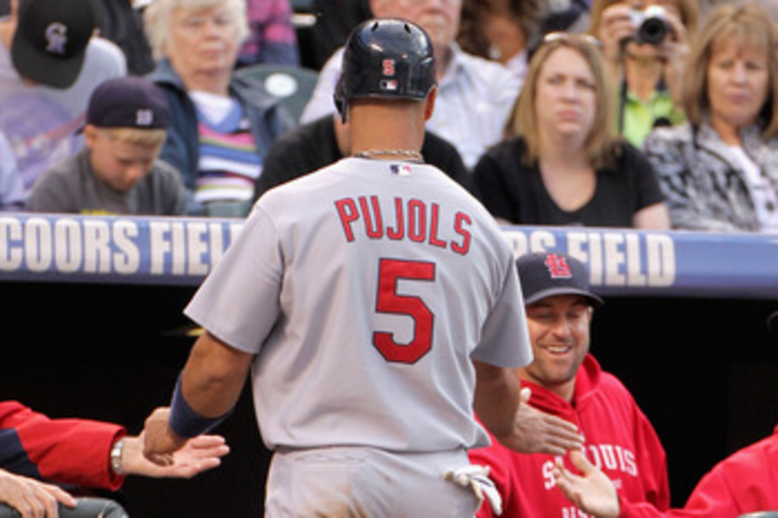 DENVER, CO - MAY 27:  Albert Pujols #5 of the St. Louis Cardinals is welcomed back to the dugout after scoring against the Colorado Rockies in the third inning at Coors Field on May 27, 2011 in Denver, Colorado.  (Photo by Doug Pensinger/Getty Images)