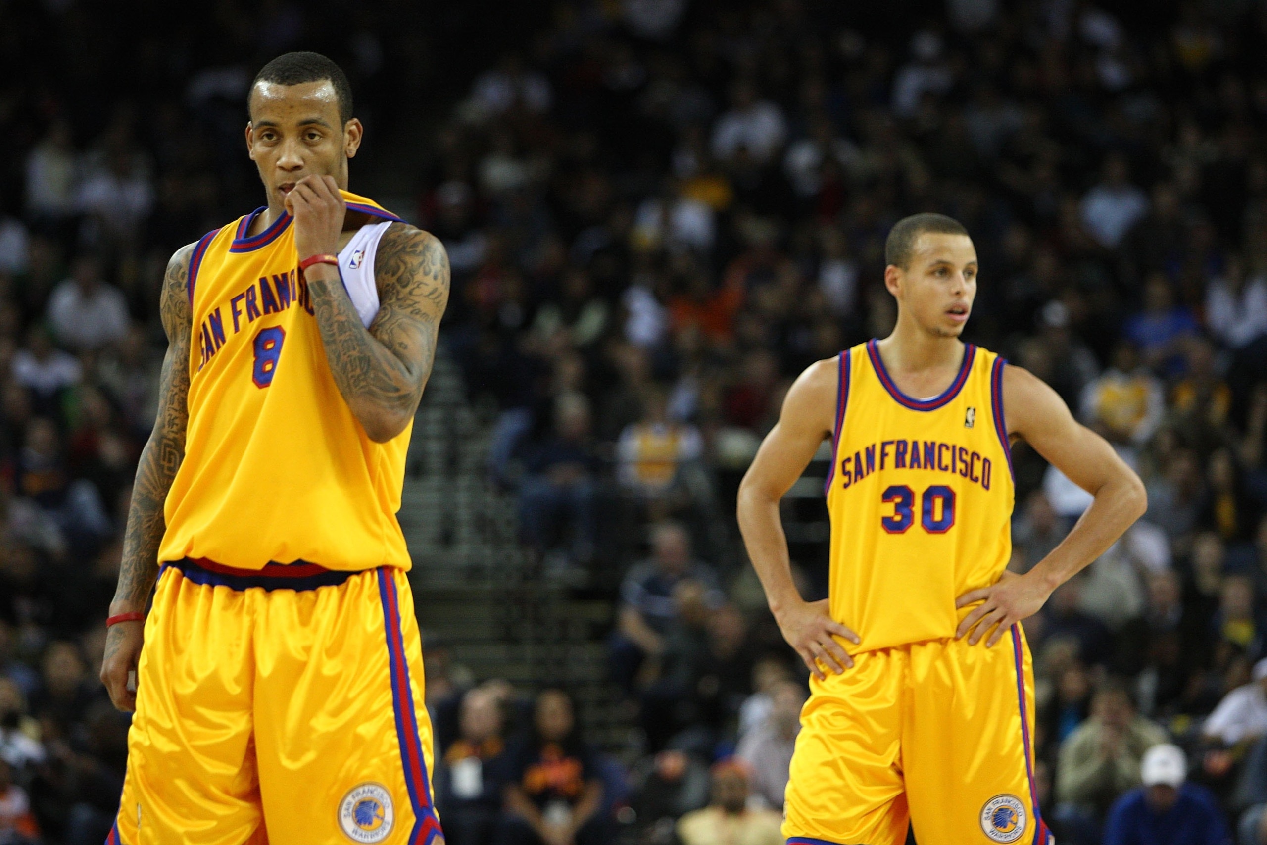 OAKLAND, CA - DECEMBER 03:  Stephen Curry #30 and Monta Ellis #8 of the Golden State Warriors look on near the end of the game against the Houston Rockets during an NBA game at Oracle Arena on December 3, 2009 in Oakland, California. NOTE TO USER: User ex