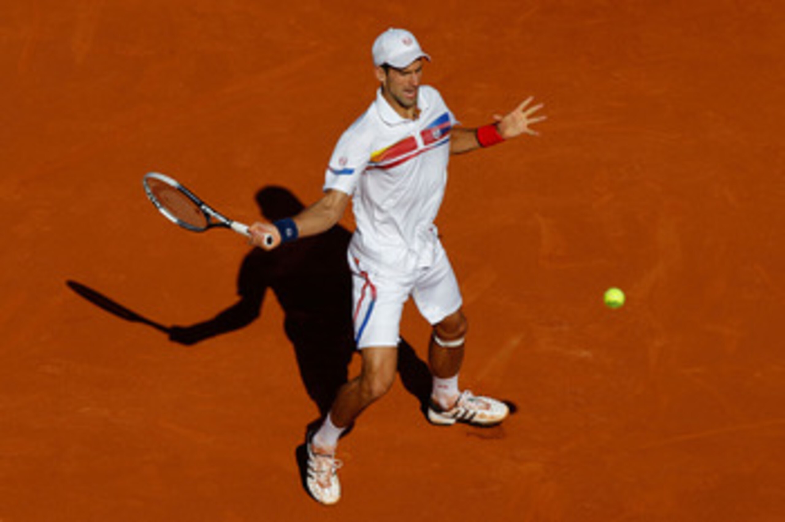 PARIS, FRANCE - MAY 29:  Novak Djokovic of Serbia hits a forehand during the men's singles round four match between Richard Gasquet of France and Novak Djokovic of Serbia on day eight of the French Open at Roland Garros on May 29, 2011 in Paris, France.  