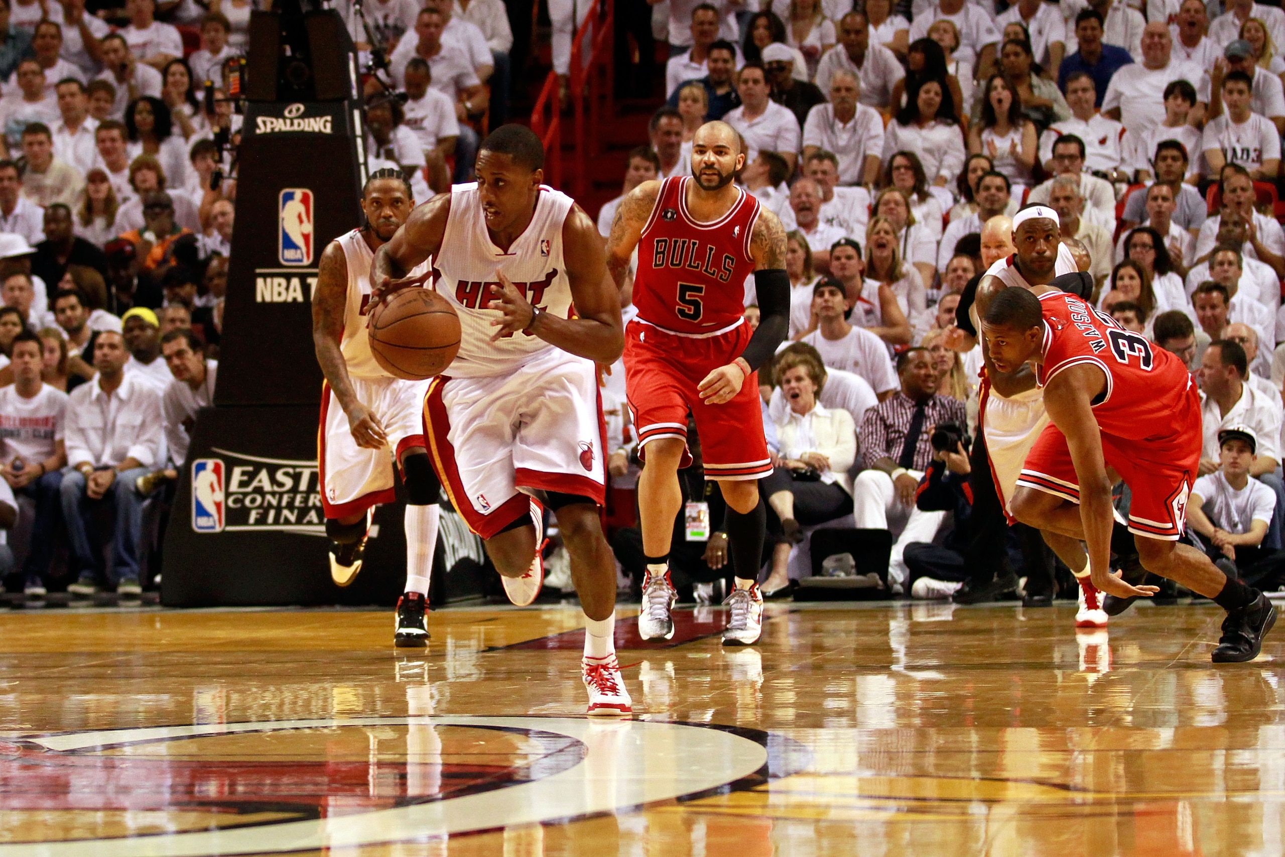 MIAMI, FL - MAY 24: Mario Chalmers #15 of the Miami Heat pushes the ball up court against the Chicago Bulls in Game Four of the Eastern Conference Finals during the 2011 NBA Playoffs on May 24, 2011 at American Airlines Arena in Miami, Florida. The Heat w
