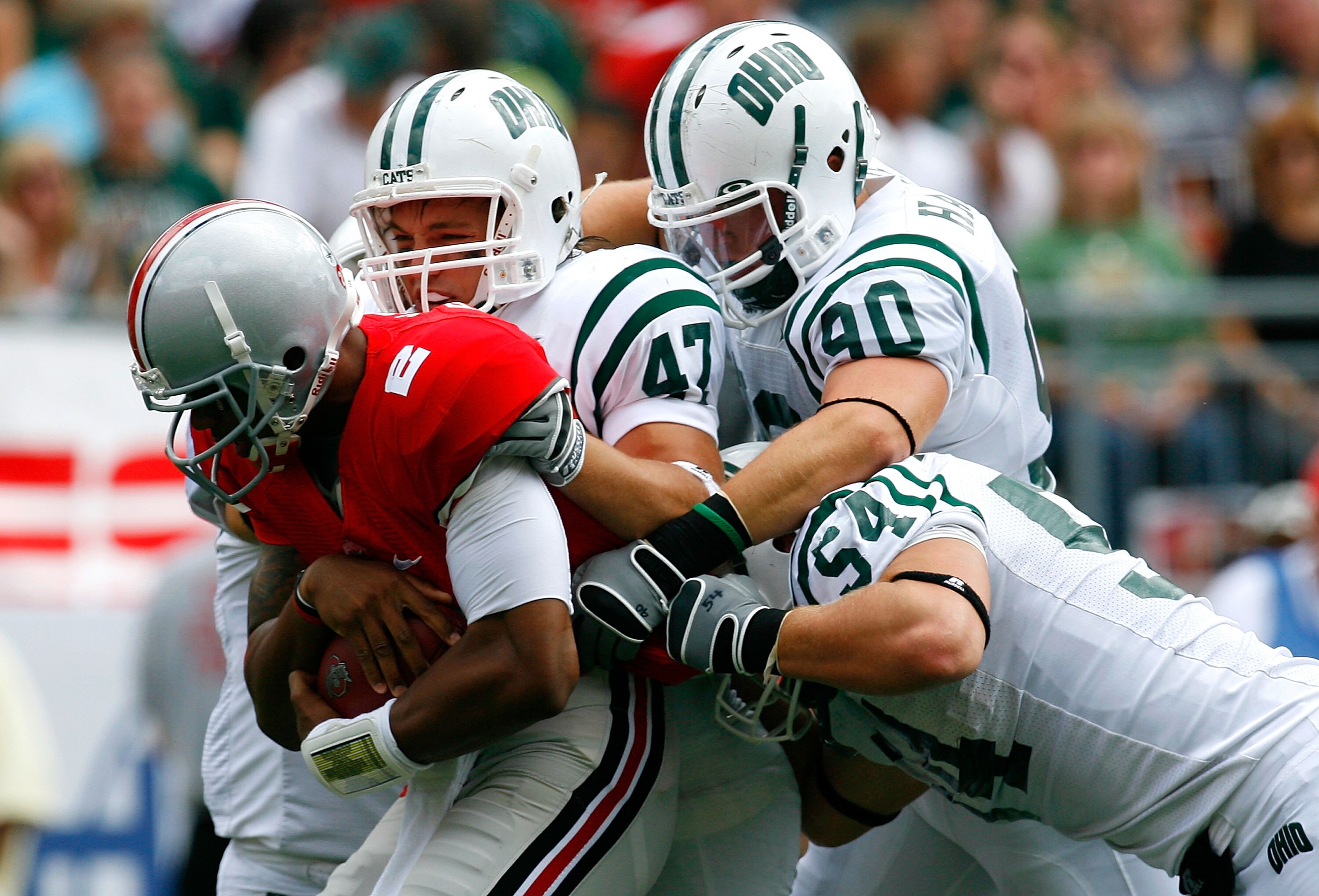 COLUMBUS, OH - SEPTEMBER 06:  Backup quarterback Terrelle Pryor #2 of the Ohio State Buckeyes is tackled by defenders Noah Keller #47, Kris Luchsinger #54 and Jameson Hartke #90 of the Ohio Bobcats during the game at Ohio Stadium on September 6, 2008 in C