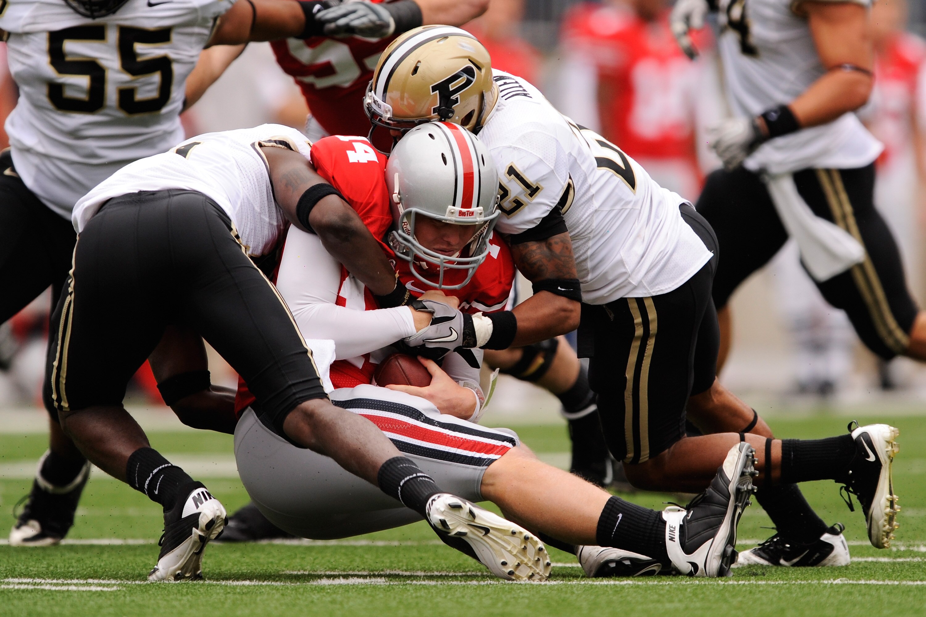 COLUMBUS, OH - OCTOBER 23:  Quarterback Joe Bauserman #14 of the Ohio State Buckeyes is sacked by Charlton Williams #15 and Ricardo Allen #21 of the Purdue Boilermakers in the second half at Ohio Stadium on October 23, 2010 in Columbus, Ohio.  (Photo by J