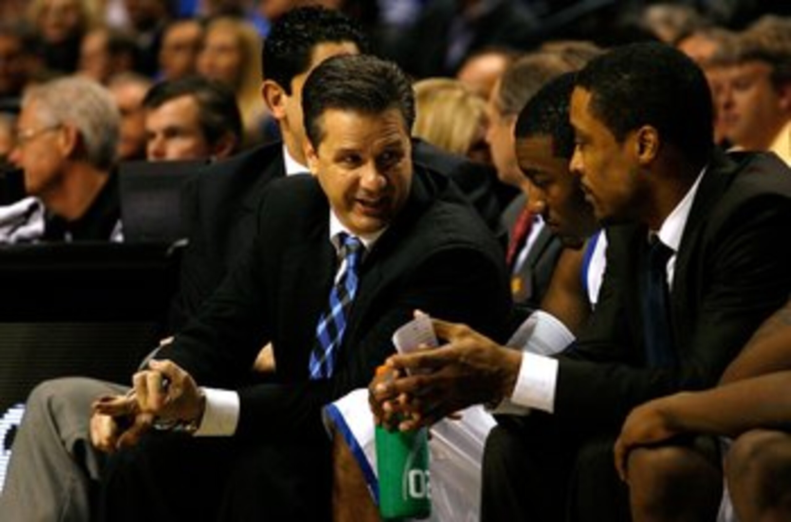 NASHVILLE, TN - MARCH 13:  (L-R) Head coach John Calipari, John Wall #11 and assistant coach Rod Strickland of the Kentucky Wildcats talk on the bench against the Tennessee Volunteers during the semifinals of the SEC Men's Basketball Tournament at the Bri