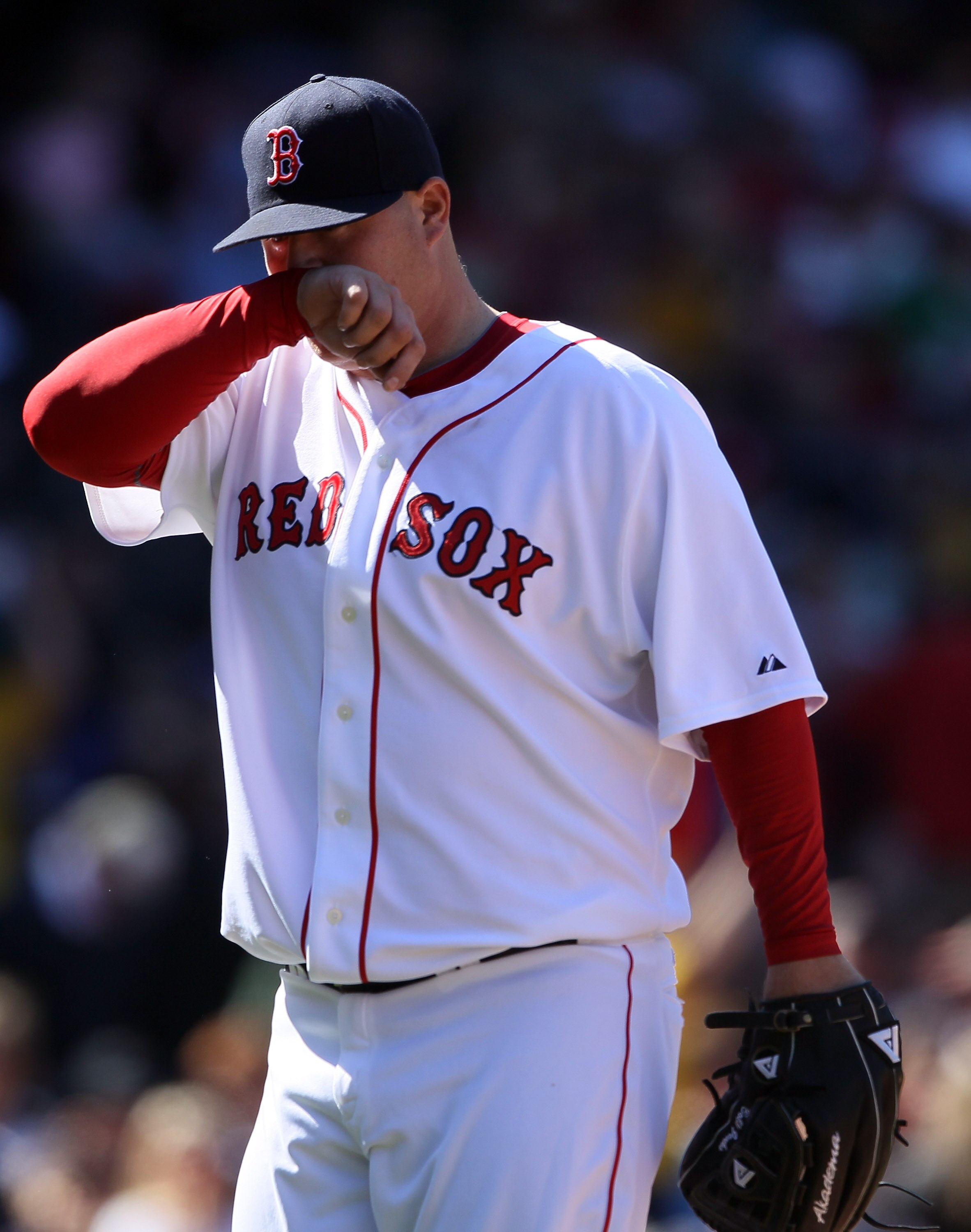 BOSTON, MA - MAY 01: Bobby Jenks #52 of the Boston Red Sox walks off the field after walking in two runs in the sixth inning against the Seattle Mariners on May 1, 2011 at Fenway Park in Boston, Massachusetts.  (Photo by Elsa/Getty Images)