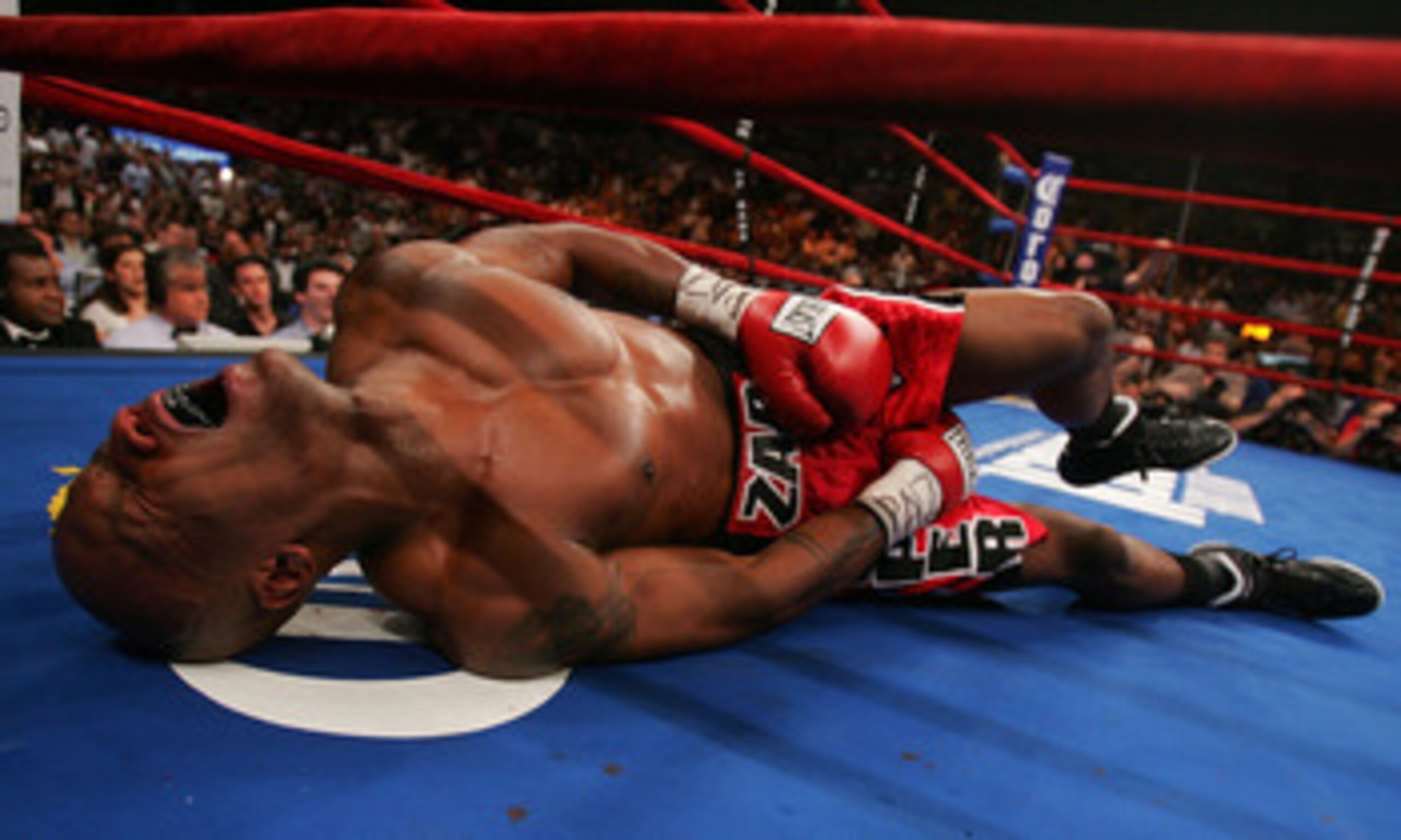NEW YORK - JUNE 9: Zab Judah lays in agony on the canvas after being hit by a second low blow by Miguel Cotto of Puerto Rico during their WBA Welterweight Championship bout on June 9, 2007 at Madison Square Garden in New York City. (Photo by Nick Laham/Ge