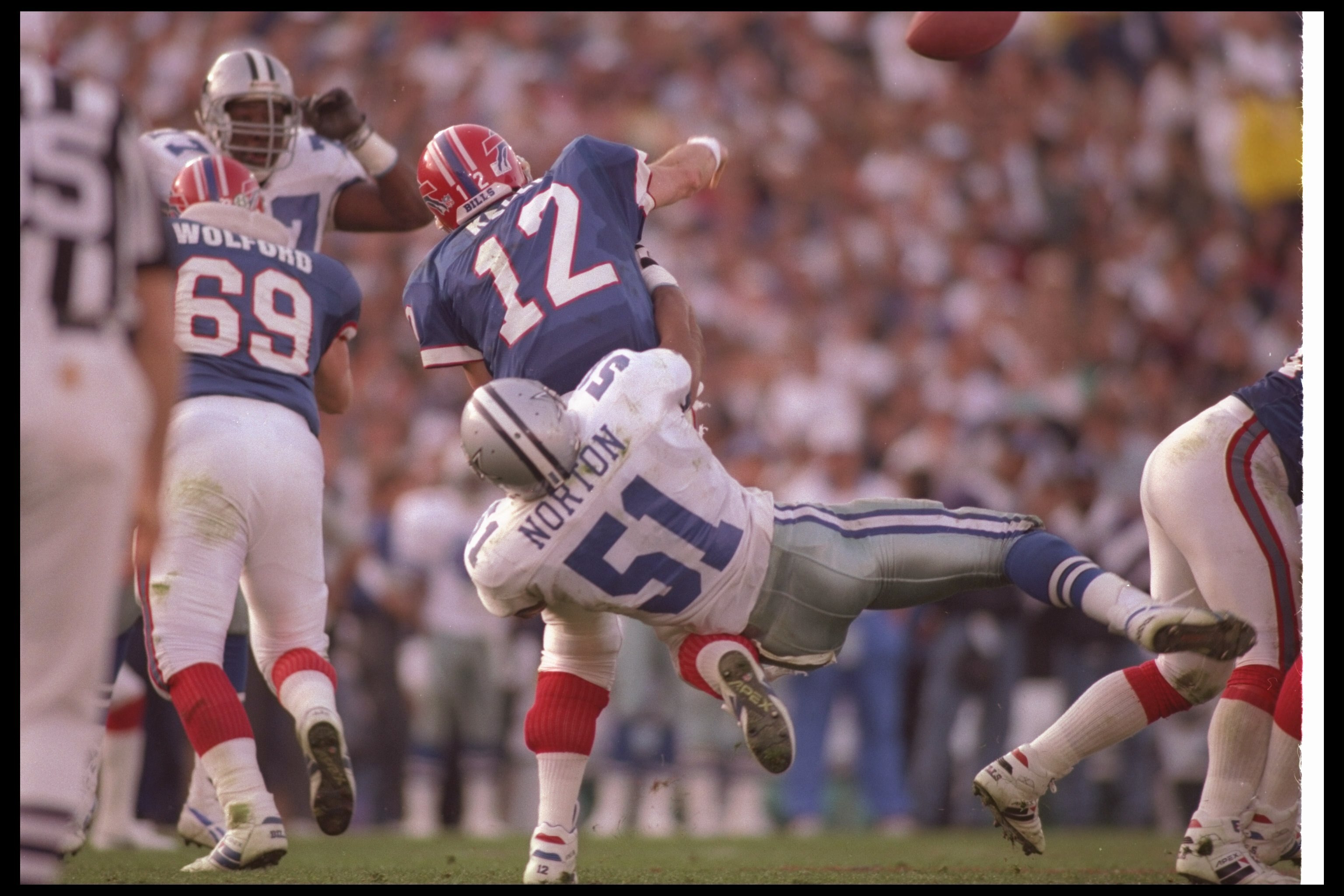 31 Jan 1993: Linebacker Ken Norton #51 of the Dallas Cowboys tackles Buffalo Bills quarterback Jim Kelly #12 during Super Bowl XXVII at the Rose Bowl in Pasadena, California. The Cowboys won the game, 52-17.