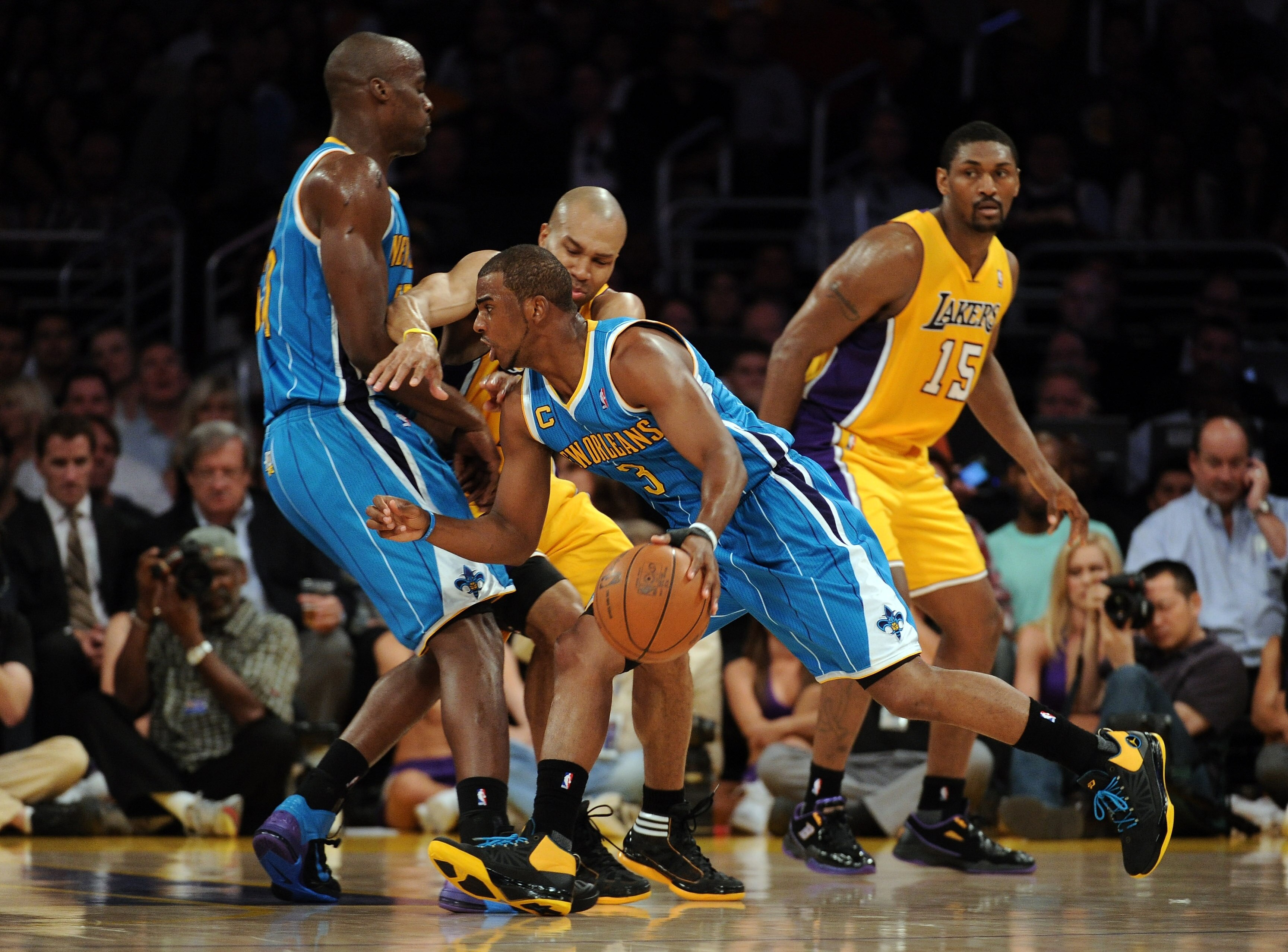LOS ANGELES, CA - APRIL 26:  Chris Paul #3 of the New Orleans Hornets moves the ball as he uses a screen by Emeka Okafor #50 against Derek Fisher #2 of the Los Angeles Lakers in the first quarter in Game Five of the Western Conference Quarterfinals in the