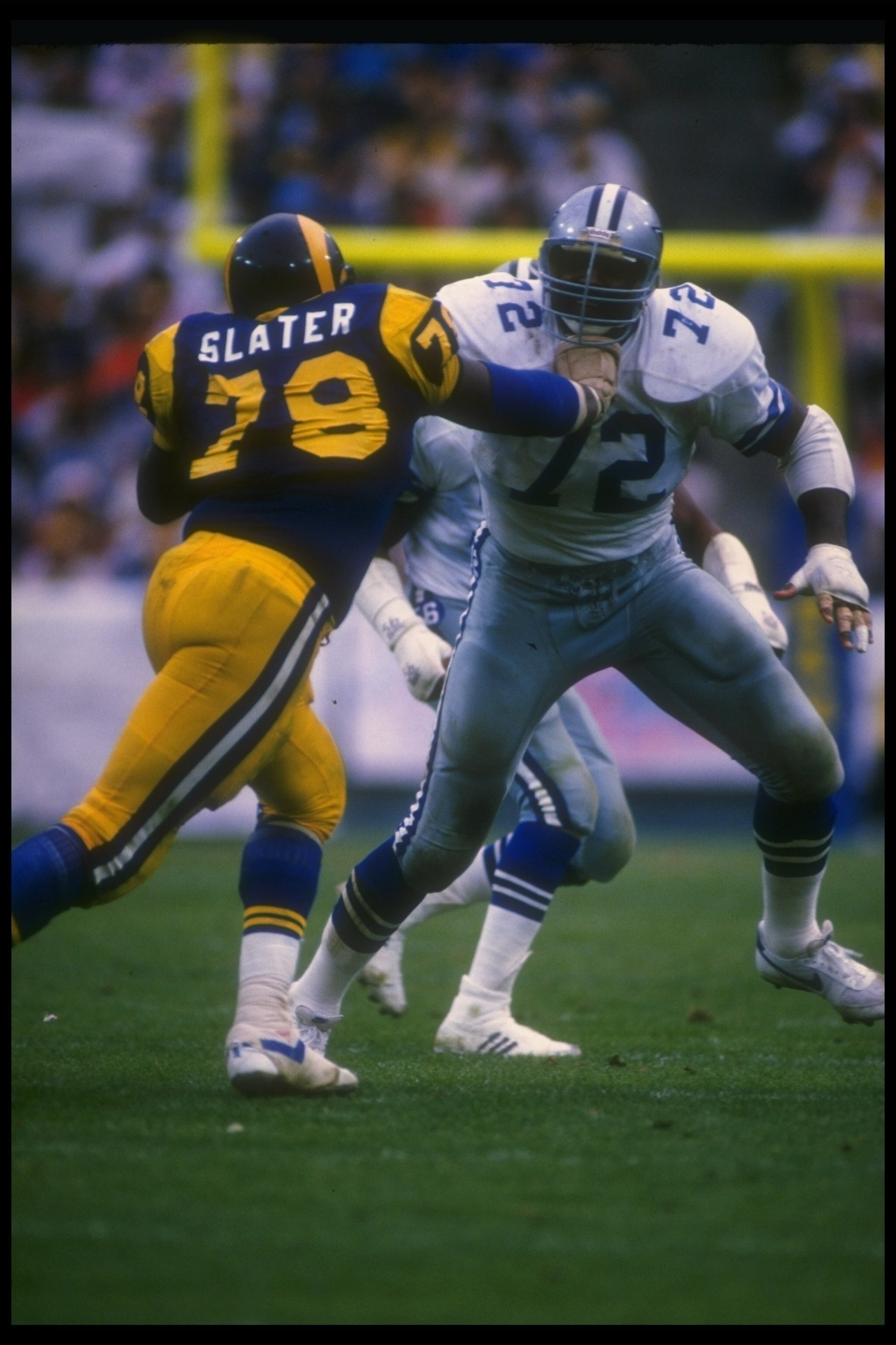 4 Jan 1986: Defensive lineman Ed Too Tall Jones of the Dallas Cowboys (right) works against Los Angeles Rams offensive lineman Jackie Slater during a playoff game at Anaheim Stadium in Anaheim, California. The Rams won the game, 20-0.
