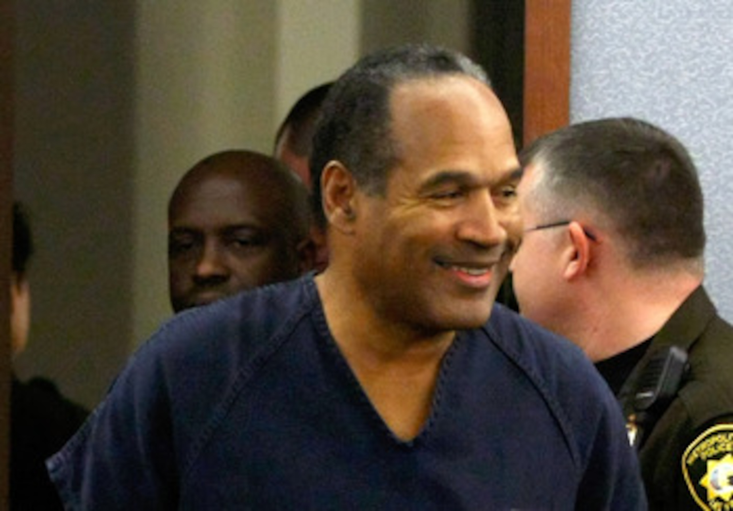 LAS VEGAS - DECEMBER 05:  O.J. Simpson smiles as he arrives in court for his sentencing hearing at the Clark County Regional Justice Center December 5, 2008 in Las Vegas, Nevada. Simpson and co-defendant Clarence 'C.J.' Stewart were sentenced on 12 charge