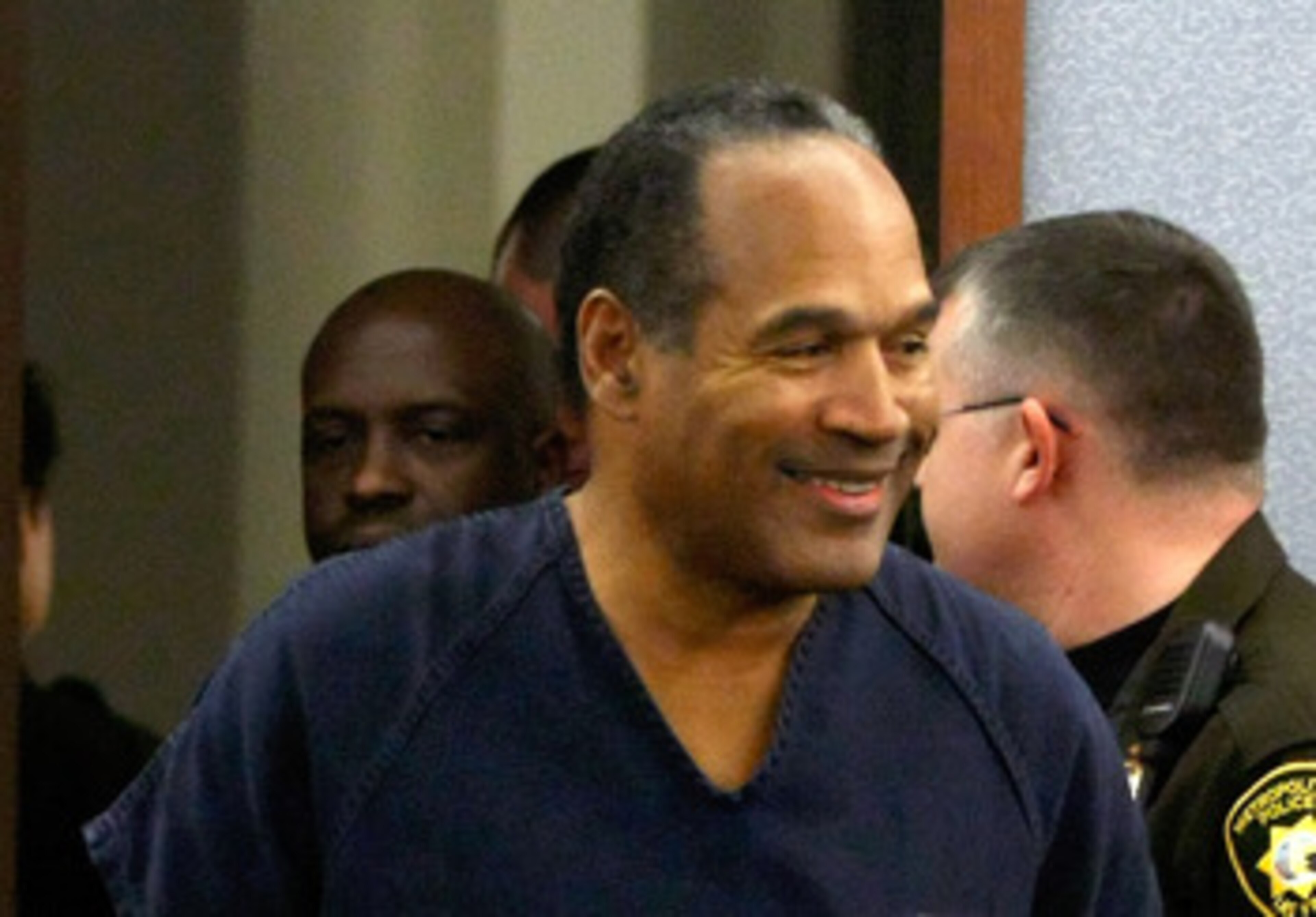 LAS VEGAS - DECEMBER 05:  O.J. Simpson smiles as he arrives in court for his sentencing hearing at the Clark County Regional Justice Center December 5, 2008 in Las Vegas, Nevada. Simpson and co-defendant Clarence 'C.J.' Stewart were sentenced on 12 charge