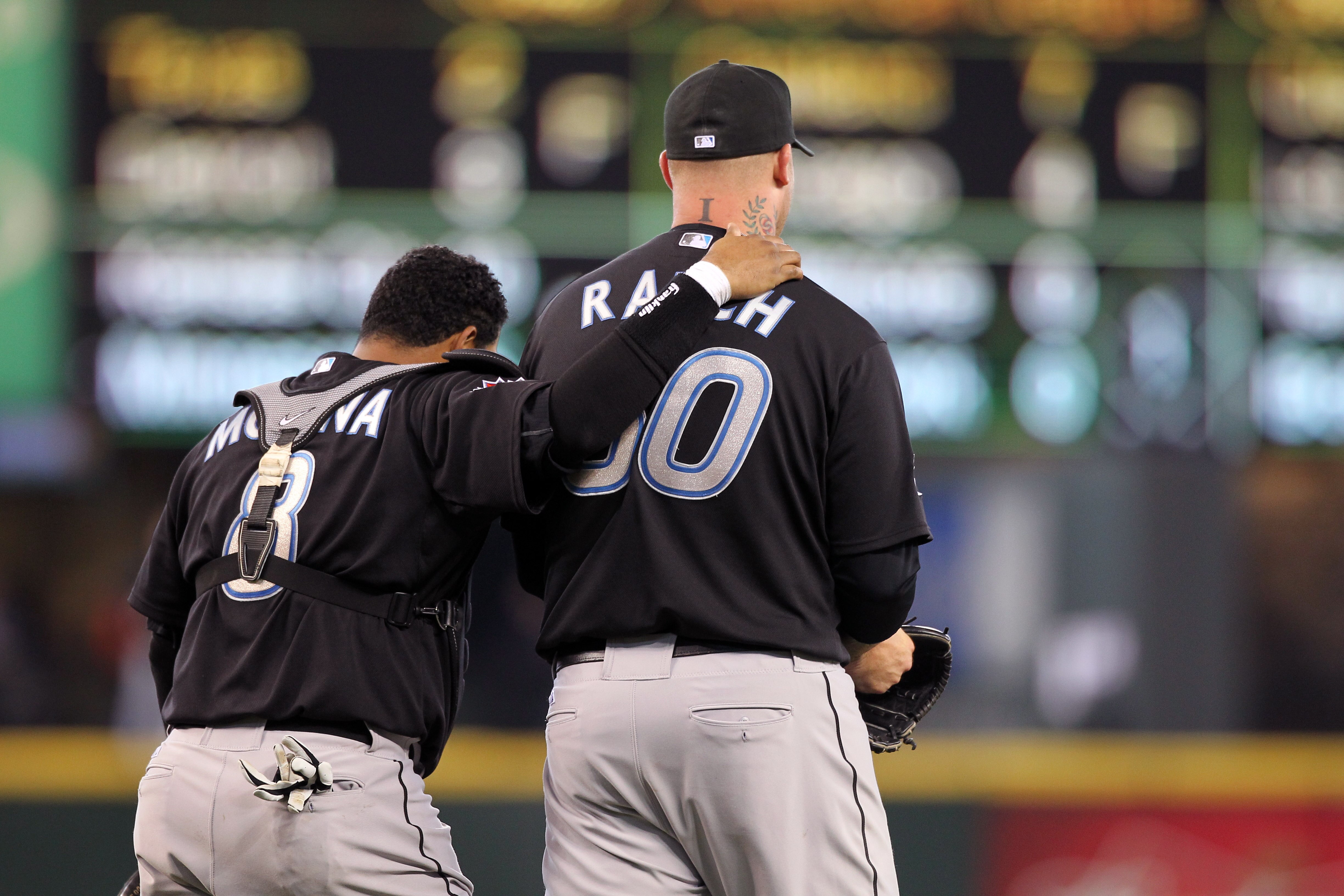 SEATTLE, WA - APRIL 13:  Catcher Jose Molina #8 of the Toronto Blue Jays congratulates closing pitcher Jon Rauch #60 after defeating the Seattle Mariners 8-3 at Safeco Field on April 13, 2011 in Seattle, Washington. (Photo by Otto Greule Jr/Getty Images)
