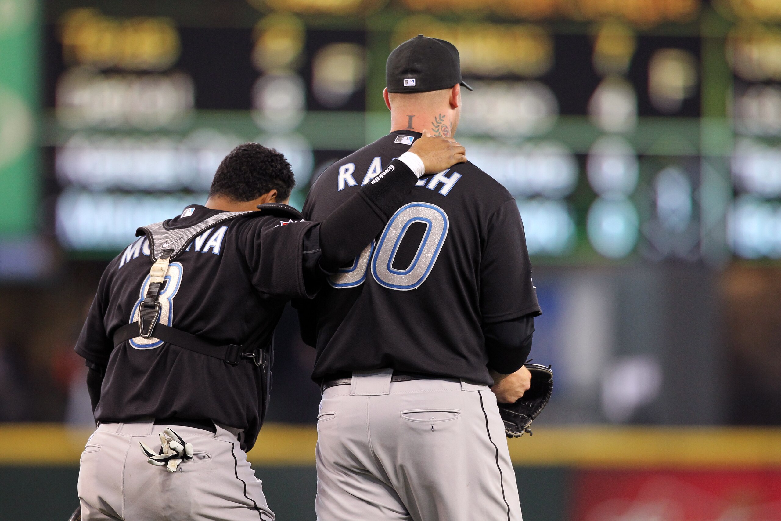 SEATTLE, WA - APRIL 13:  Catcher Jose Molina #8 of the Toronto Blue Jays congratulates closing pitcher Jon Rauch #60 after defeating the Seattle Mariners 8-3 at Safeco Field on April 13, 2011 in Seattle, Washington. (Photo by Otto Greule Jr/Getty Images)