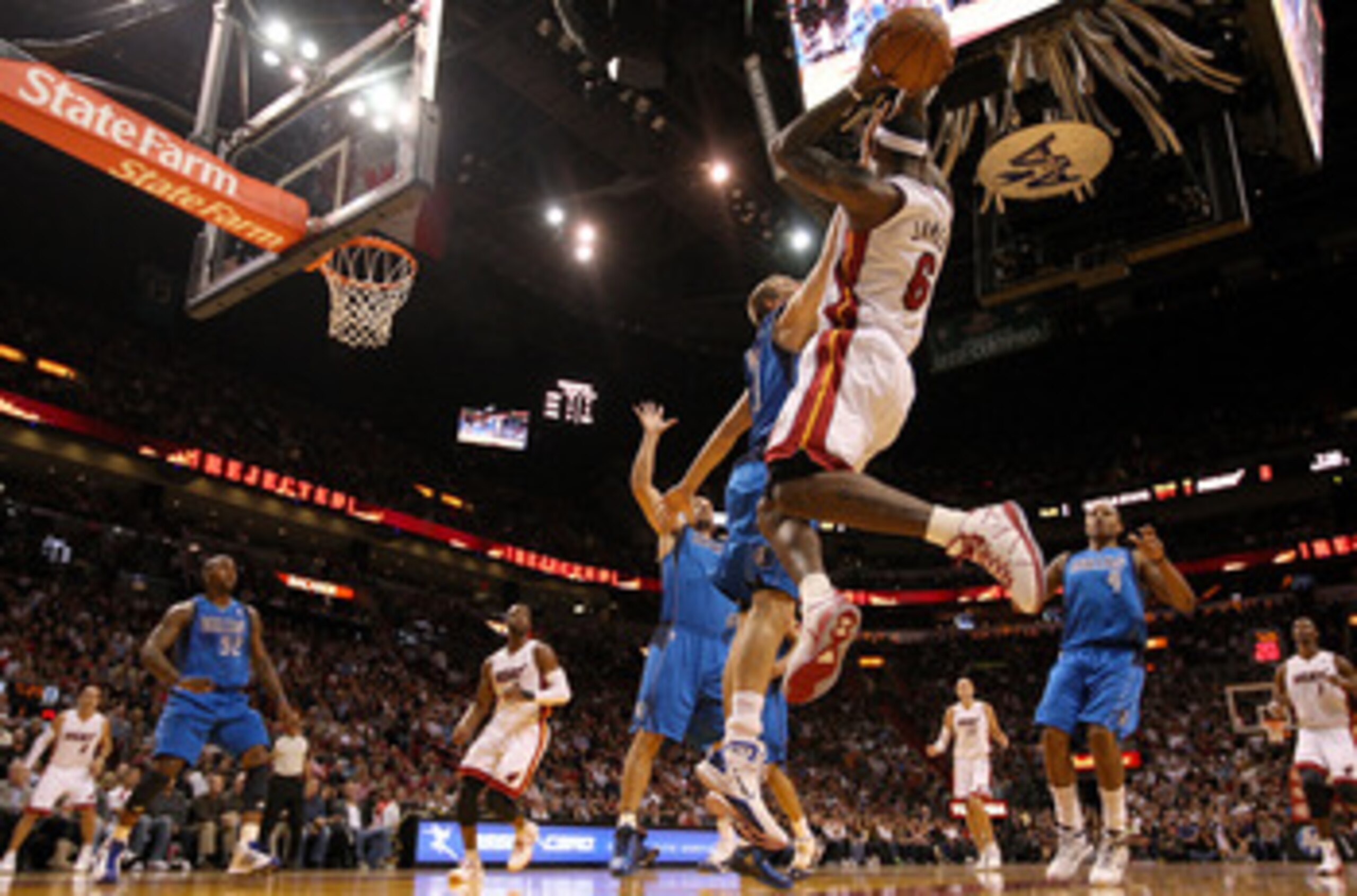 MIAMI, FL - DECEMBER 20:  LeBron James #6 of the Miami Heat passes over Dirk Nowitzki #41 of the Dallas Mavericks  during a game at American Airlines Arena on December 20, 2010 in Miami, Florida. NOTE TO USER: User expressly acknowledges and agrees that,