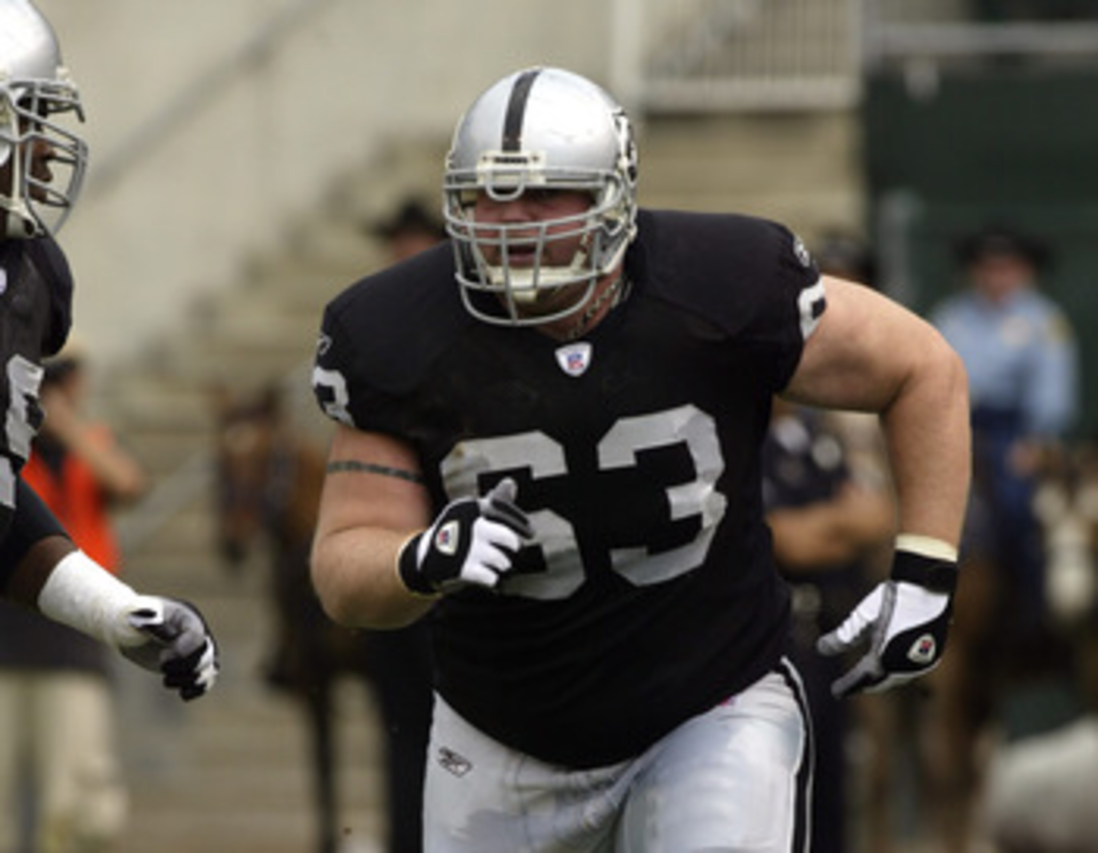 OAKLAND, CA  - SEPTEMBER 28:  Center Barrett Robbins #63 of the Oakland Raiders runs to block during a game against the San Diego Chargers on September 28, 2003 at Network Associates Coliseum in Oakland, California. The Raiders defeated the Chargers 34-31