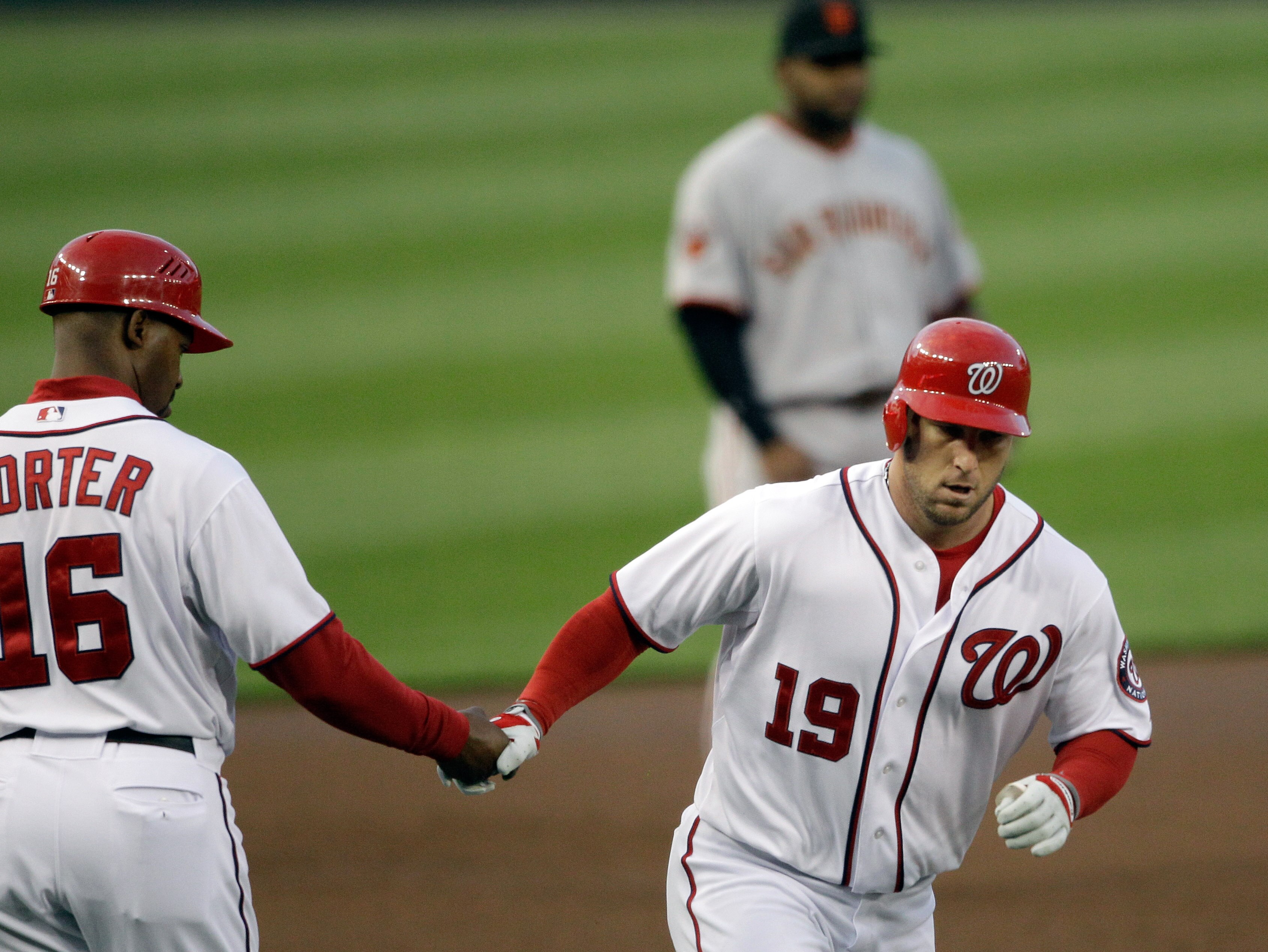 WASHINGTON, DC - APRIL 29:  Laynce Nix #19 of the Washington Nationals celebrates his two run homer with third base coach Bo Porter #16 during the second inning at Nationals Park on April 29, 2011 in Washington, DC.  (Photo by Rob Carr/Getty Images)