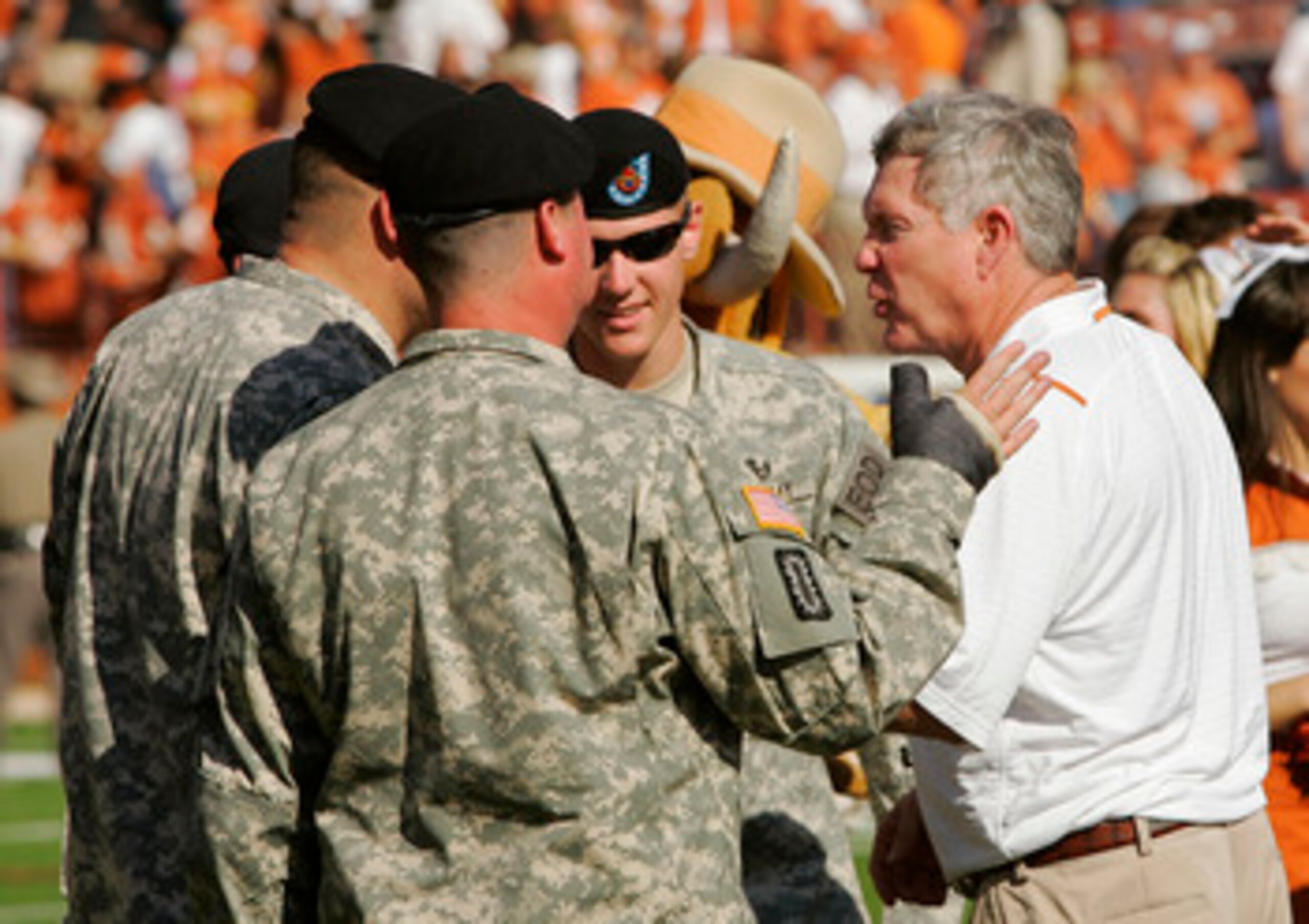 AUSTIN, TX - NOVEMBER 07:  Head coach Mack Brown of the Texas Longhorns greets soldiers from Ft. Hood after defeating the UCF Knights on November 7, 2009 at Darrell K Royal - Texas Memorial Stadium in Austin, Texas.  Texas won 35-3.  (Photo by Brian Bahr/