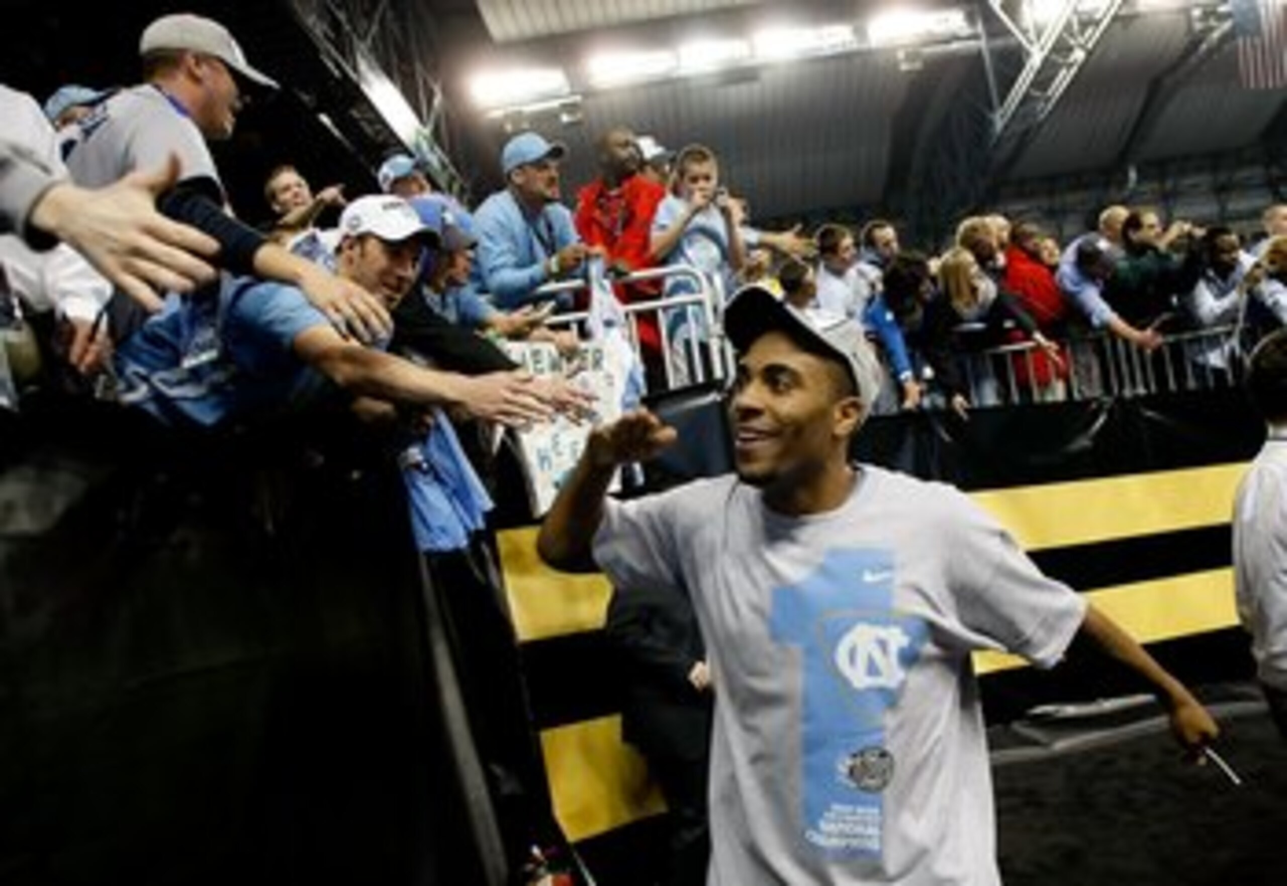 DETROIT - APRIL 06:  Wayne Ellington #22 of the North Carolina Tar Heels celebrates with fans as he run off the court after the Tar Heels 89-72 win against the Michigan State Spartans during the 2009 NCAA Division I Men's Basketball National Championship 