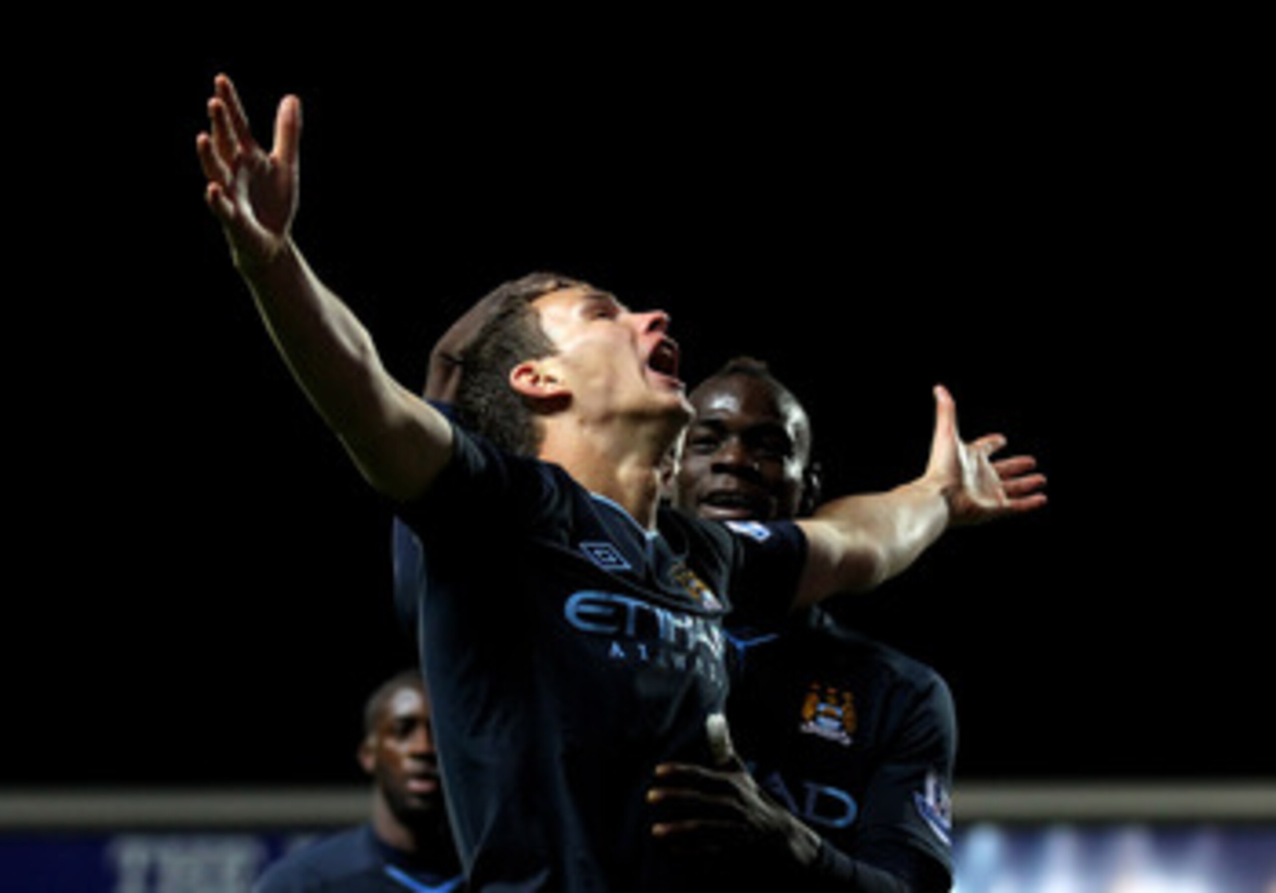 BLACKBURN, ENGLAND - APRIL 25: Edin Dzeko of Manchester City celebrates scoring the opening goal with team mate Mario Balotelli during the Barclays Premier League match between Blackburn Rovers and Manchester City at Ewood Park on April 25, 2011 in Black BLACKBURN, ENGLAND - APRIL 25: Edin Dzeko of Manchester City celebrates scoring the opening goal with team mate Mario Balotelli during the Barclays Premier League match between Blackburn Rovers and Manchester City at Ewood Park on April 25, 2011 in Black