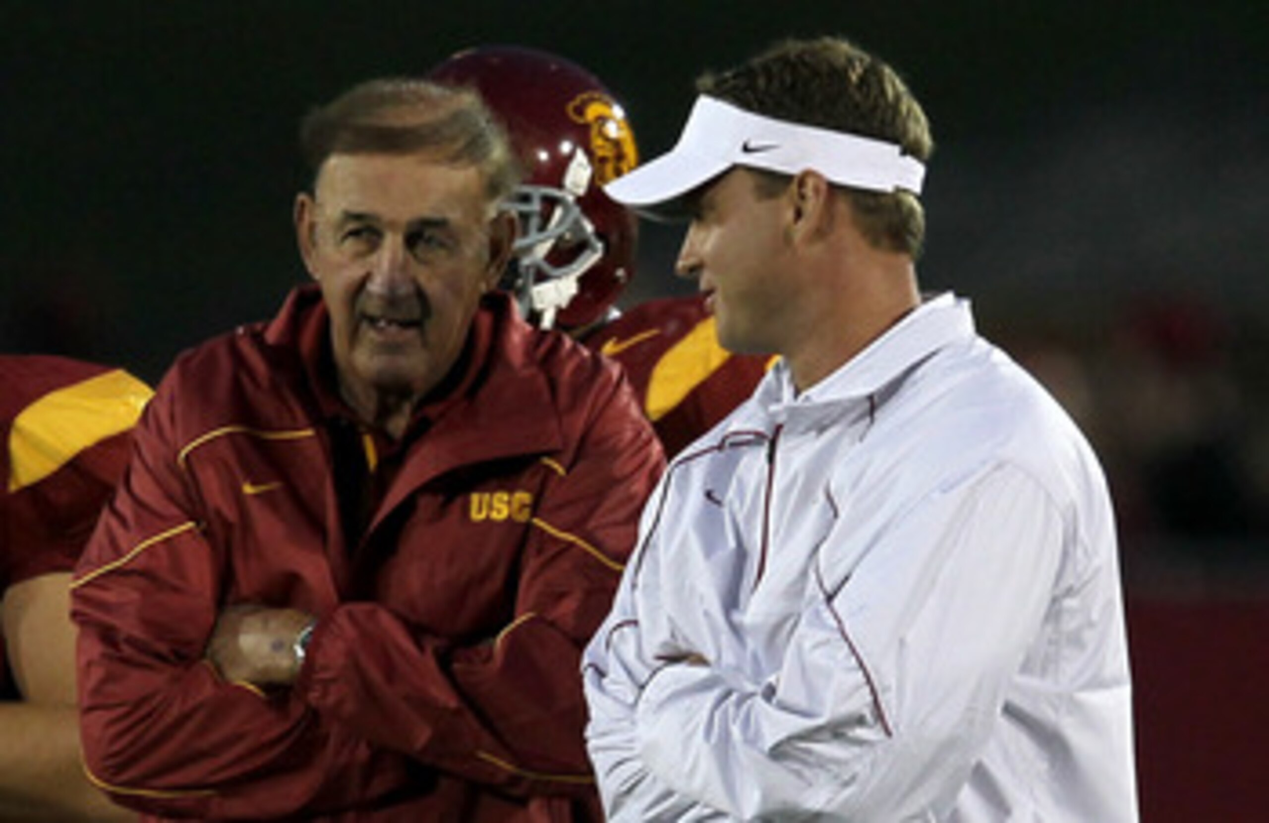 LOS ANGELES, CA - SEPTEMBER 11:  Head coach Lane Kiffin (R) and his father and defensive coordinator Monte Kiffin of the USC Trojans  talk during warmups for their game with the Virginia Cavaliers at Los Angeles Memorial Coliseum on September 11, 2010 in