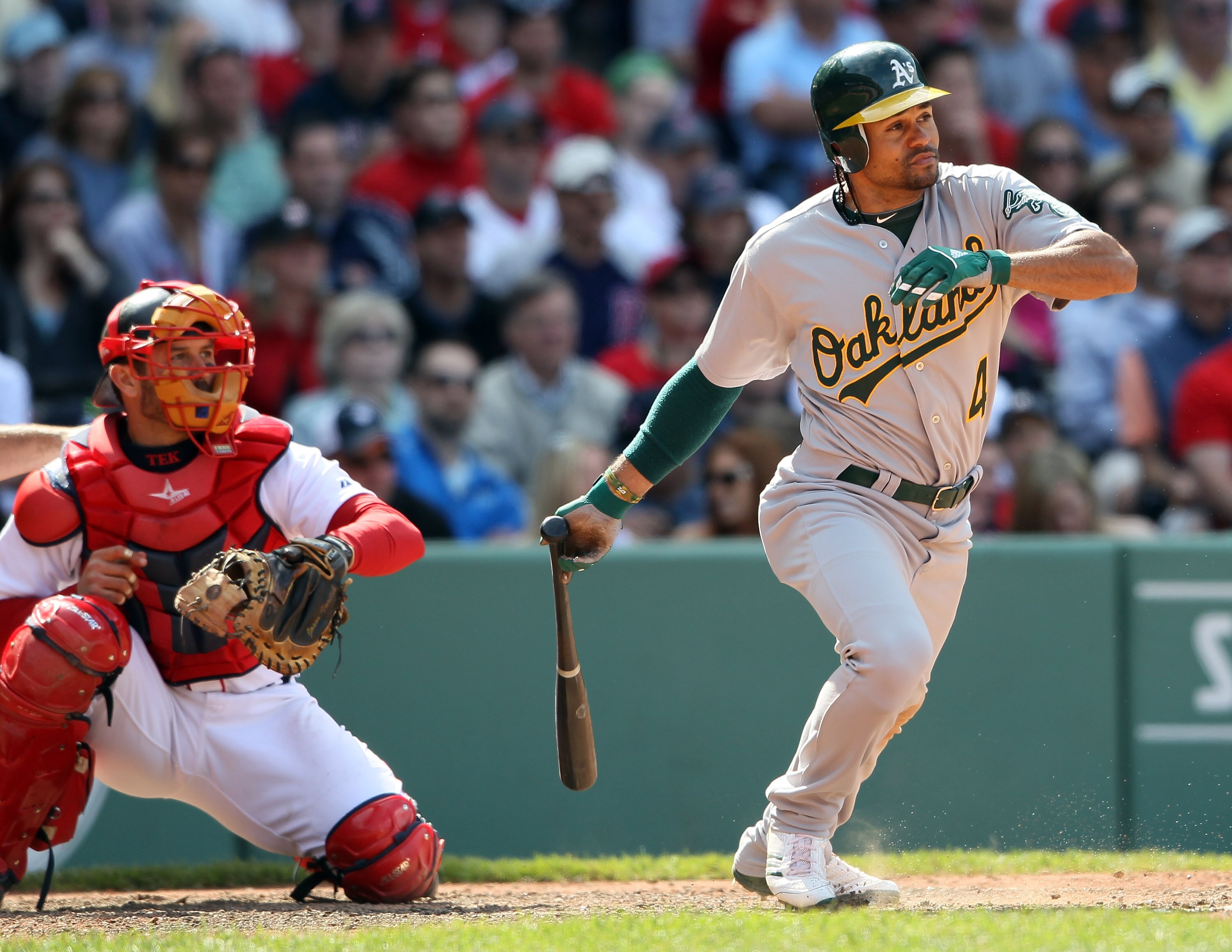 BOSTON, MA - JUNE 04:  Coco Crisp #4 of the Oakland Athletics hits a single in the ninth inning as Jason Varitek #33 of the Boston Red Sox catches on June 4, 2011 at Fenway Park in Boston, Massachusetts.  (Photo by Elsa/Getty Images)