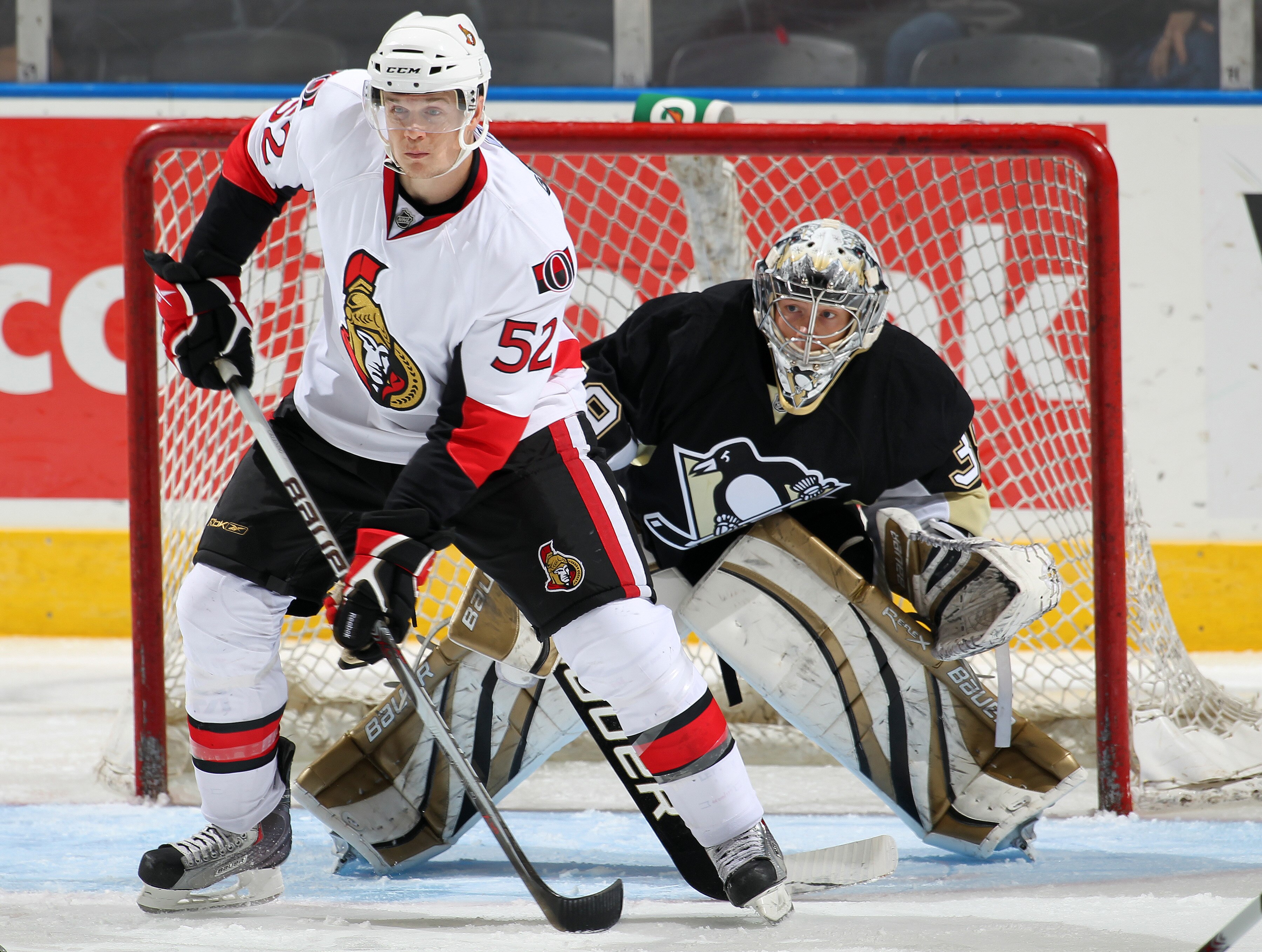 LONDON, CANADA - SEPTEMBER 11: Colin Greening #52 of the Ottawa Senators waits to tip a shot in front of Brad Thiessen #39 of the Pittsburgh Penguins in a game during the NHL Rookie Tournament on September 11, 2010 at the John Labatt Centre in London, Ont