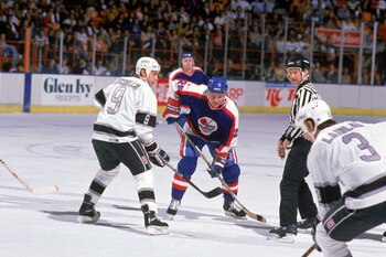 INGLEWOOD, CA - 1988:  Bernie Nicholls #9 of the Los Angeles Kings lines up for the face-off against Thomas Steen #25 of the Winnipeg Jets during their game at the Great Western Forum circa 1988 in Inglewood, California.  (Photo by Mike Powell/Getty Image