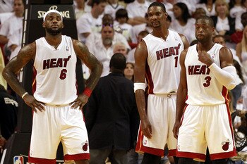 MIAMI, FL - APRIL 16:  Forward Chris Bosh #1 of the  Miami Heat with teammates Dwyane Wade #3 and LeBron James #6 against the Philadelphia 76ers at the American Airlines Arena in Game One of the Eastern Conference Quarterfinals in the 2011 NBA Playoffs on