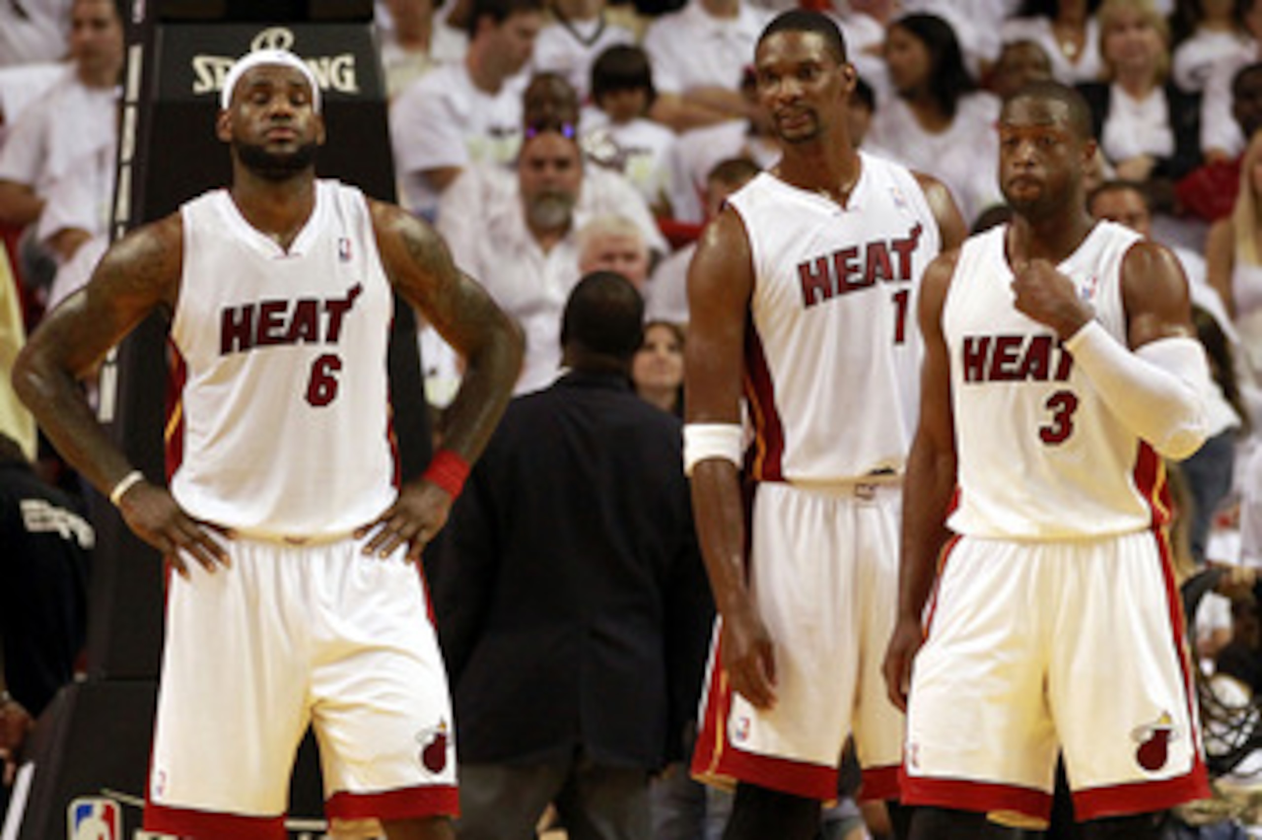 MIAMI, FL - APRIL 16:  Forward Chris Bosh #1 of the  Miami Heat with teammates Dwyane Wade #3 and LeBron James #6 against the Philadelphia 76ers at the American Airlines Arena in Game One of the Eastern Conference Quarterfinals in the 2011 NBA Playoffs on
