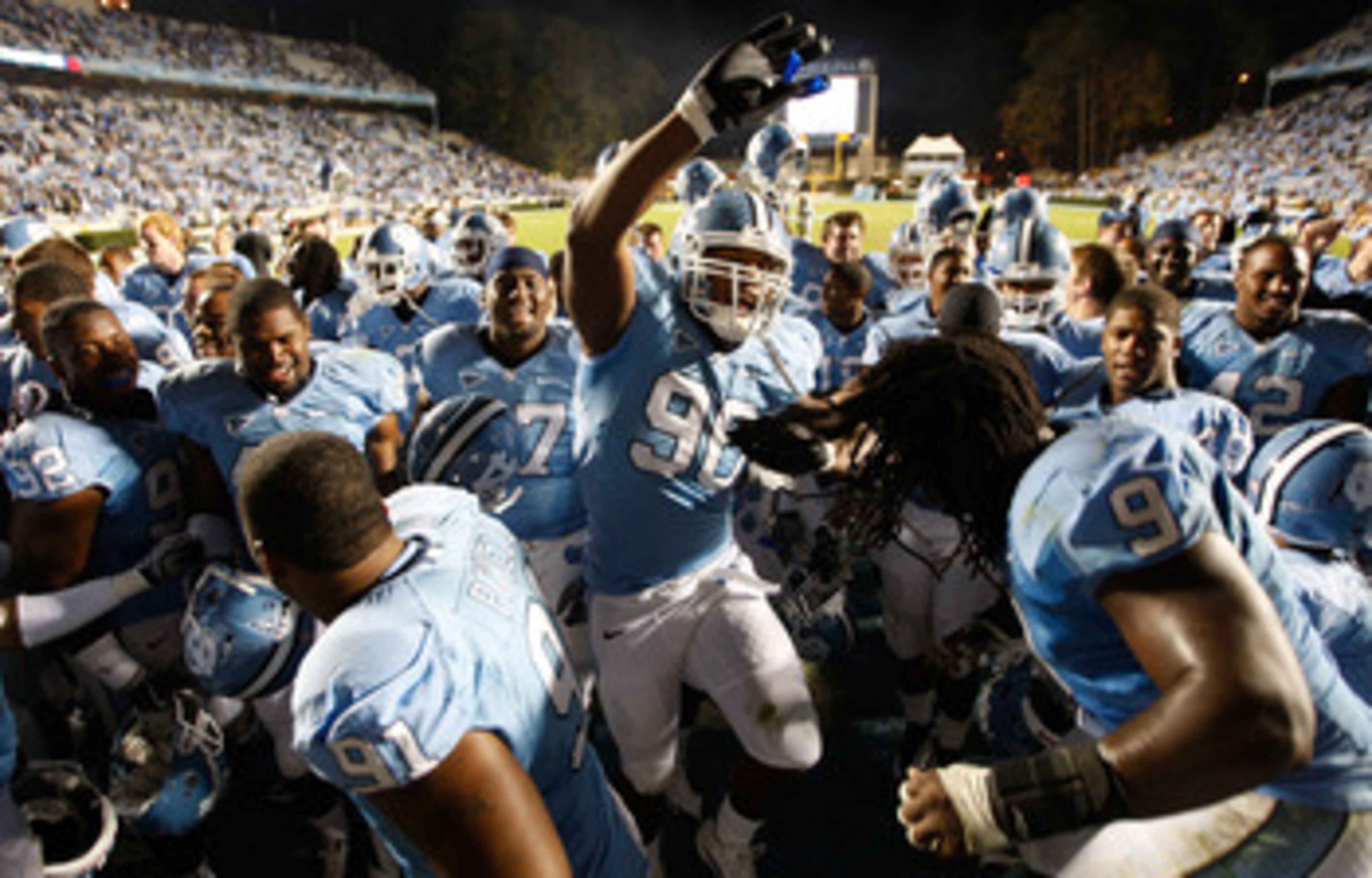 CHAPEL HILL, NC - NOVEMBER 07:  Quinton Coples #90 of the North Carolina Tar Heels celebrates with teammates after a 19-6 victory over the Duke Blue Devils during their game at Kenan Stadium on November 7, 2009 in Chapel Hill, North Carolina.  (Photo by S