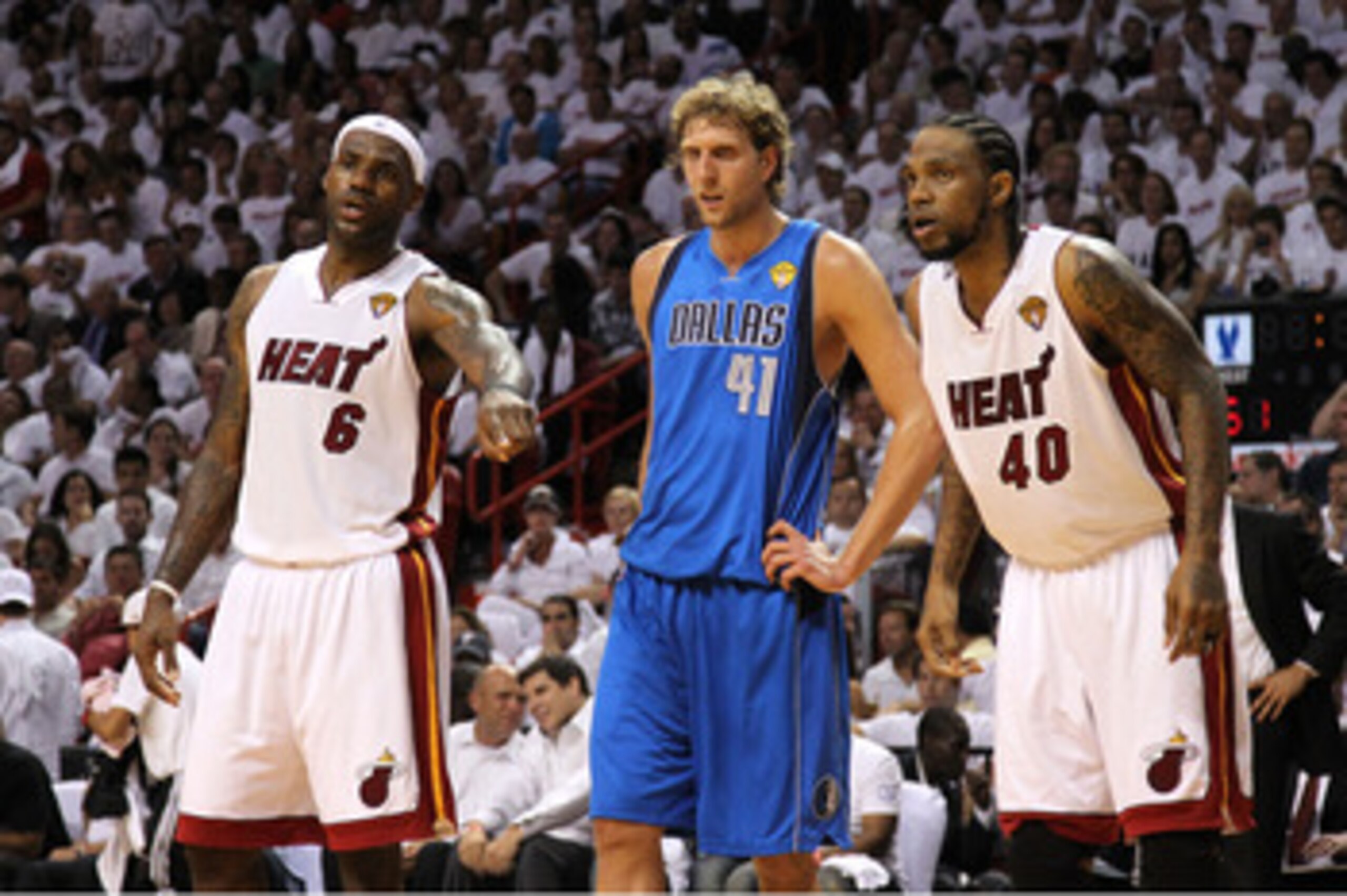 MIAMI, FL - MAY 31:  LeBron James #6 (L) and Udonis Haslem #40 of the Miami Heat look on as they Dirk Nowitzki #41 of the Dallas Mavericks stands between them as they await a free throw attempt in Game One of the 2011 NBA Finals at American Airlines Arena