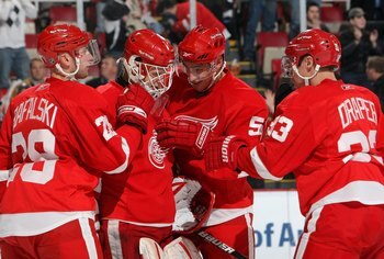 DETROIT - FEBRUARY 12:  Brian Rafalski #28, Valtteri Filppula #51 and Kris Draper #33 of the Detroit Red Wings congratulates goaltender Chris Osgood #30 after their NHL game against the Minnesota Wild at Joe Louis Arena on February 12, 2009 in Detroit, Mi