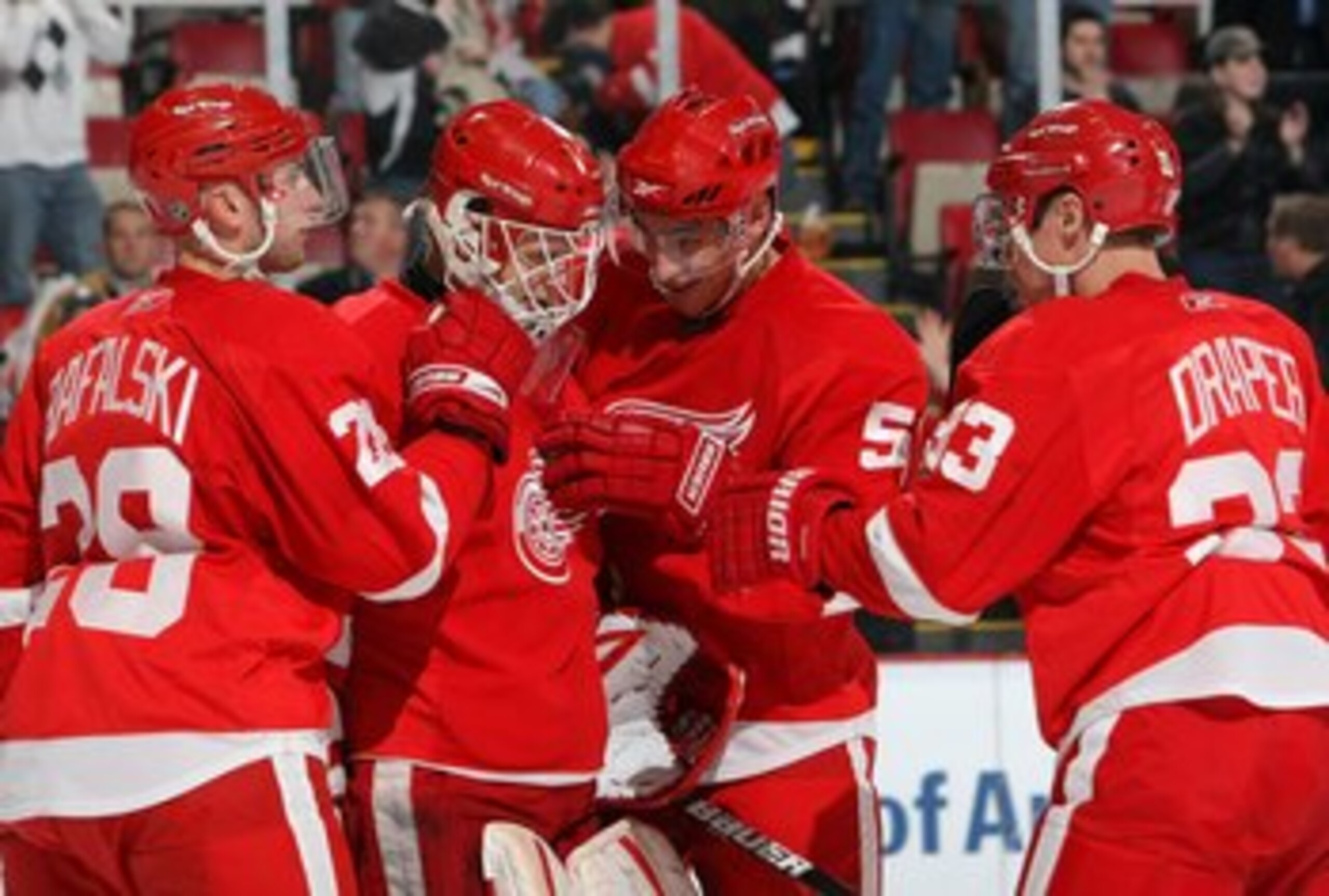 DETROIT - FEBRUARY 12:  Brian Rafalski #28, Valtteri Filppula #51 and Kris Draper #33 of the Detroit Red Wings congratulates goaltender Chris Osgood #30 after their NHL game against the Minnesota Wild at Joe Louis Arena on February 12, 2009 in Detroit, Mi