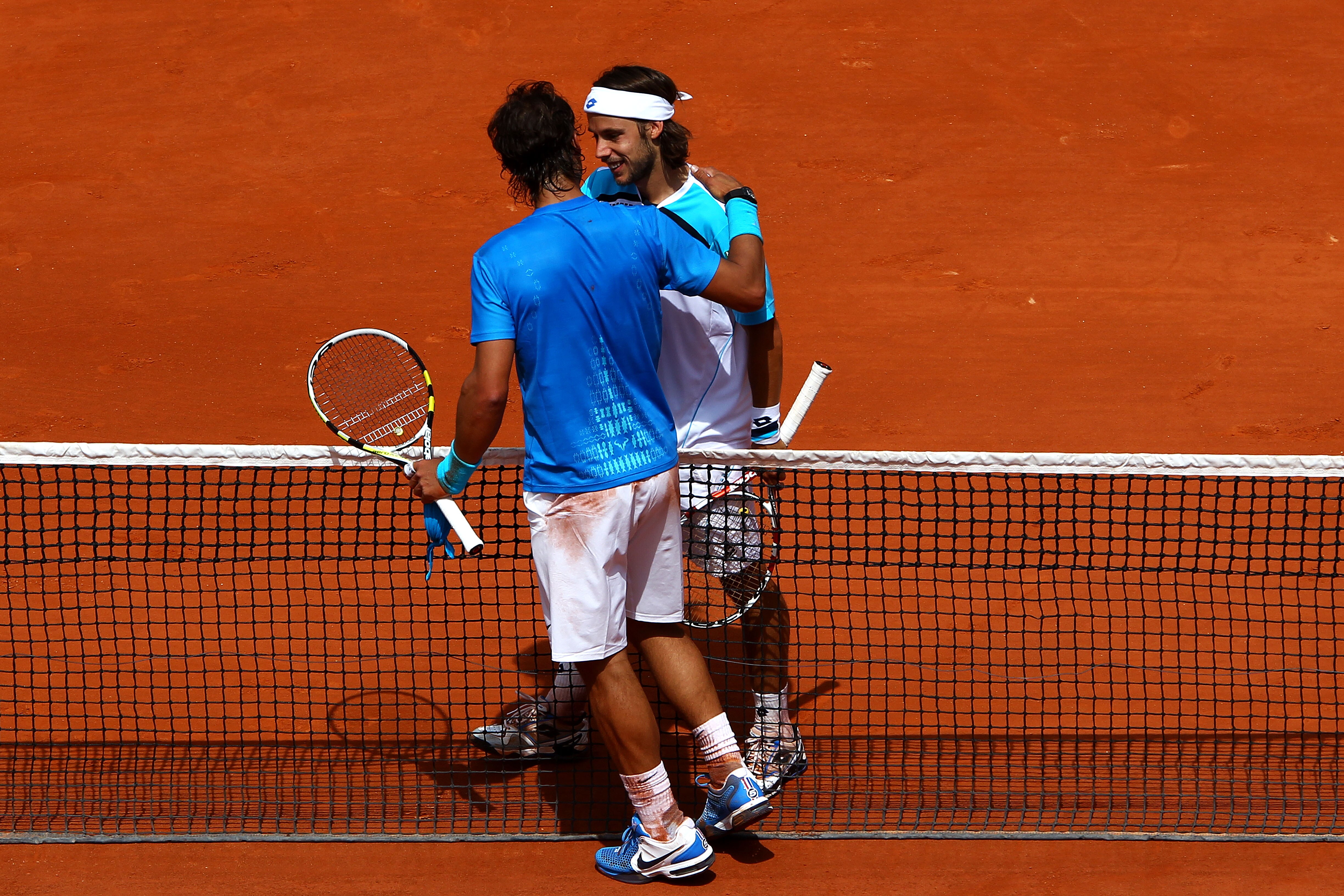 PARIS, FRANCE - MAY 28:  Rafael Nadal of Spain meets Antonio Veic of Croatia at the net after their men's singles round three match on day seven of the French Open at Roland Garros on May 28, 2011 in Paris, France.  (Photo by Clive Brunskill/Getty Images)
