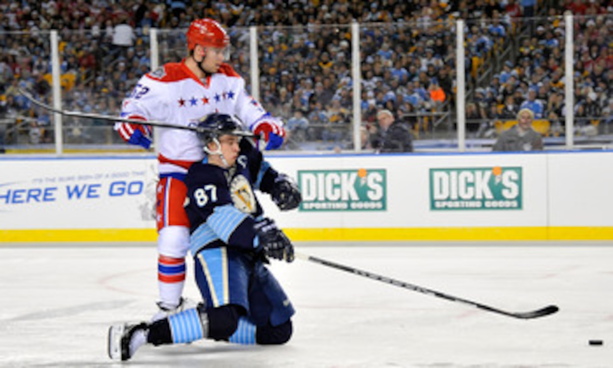 PITTSBURGH, PA - JANUARY 01: Sidney Crosby #87 of the Pittsburgh Penguins battles for the puck against Mike Green #52 of the Washington Capitals during the 2011 NHL Bridgestone Winter Classic at Heinz Field on January 1, 2011 in Pittsburgh, Pennsylvania. PITTSBURGH, PA - JANUARY 01: Sidney Crosby #87 of the Pittsburgh Penguins battles for the puck against Mike Green #52 of the Washington Capitals during the 2011 NHL Bridgestone Winter Classic at Heinz Field on January 1, 2011 in Pittsburgh, Pennsylvania.