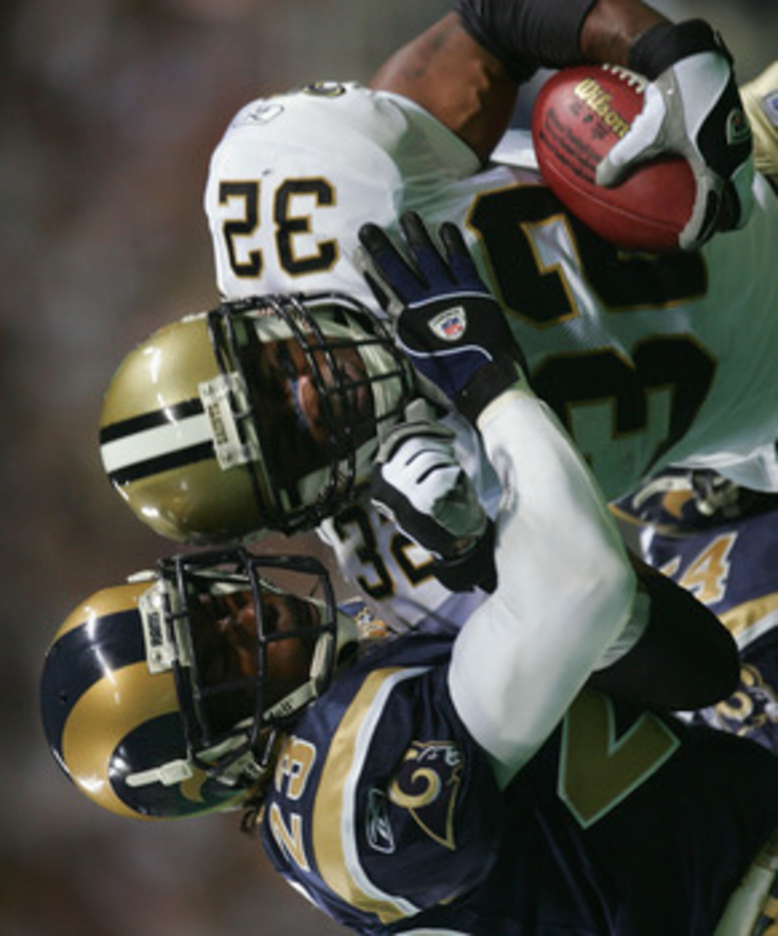 ST. LOUIS - SEPTEMBER 26: Ki-Jana Carter #32 of the New Orleans Saints tries to break the tackle of Jeramitrius Butler #23 of the St. Louis Rams during the third quarter at the Edward Jones Dome on September 26, 2004 in St. Louis, Missouri. The Saints w ST. LOUIS - SEPTEMBER 26: Ki-Jana Carter #32 of the New Orleans Saints tries to break the tackle of Jeramitrius Butler #23 of the St. Louis Rams during the third quarter at the Edward Jones Dome on September 26, 2004 in St. Louis, Missouri. The Saints w