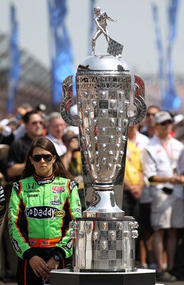 INDIANAPOLIS, IN - MAY 29:  Danica Patrick, driver of the #7 Team GoDaddy Dallara Honda, stands next to the Borg-Warner Trophy prior to the IZOD IndyCar Series Indianapolis 500 Mile Race at Indianapolis Motor Speedway on May 29, 2011 in Indianapolis, Indi