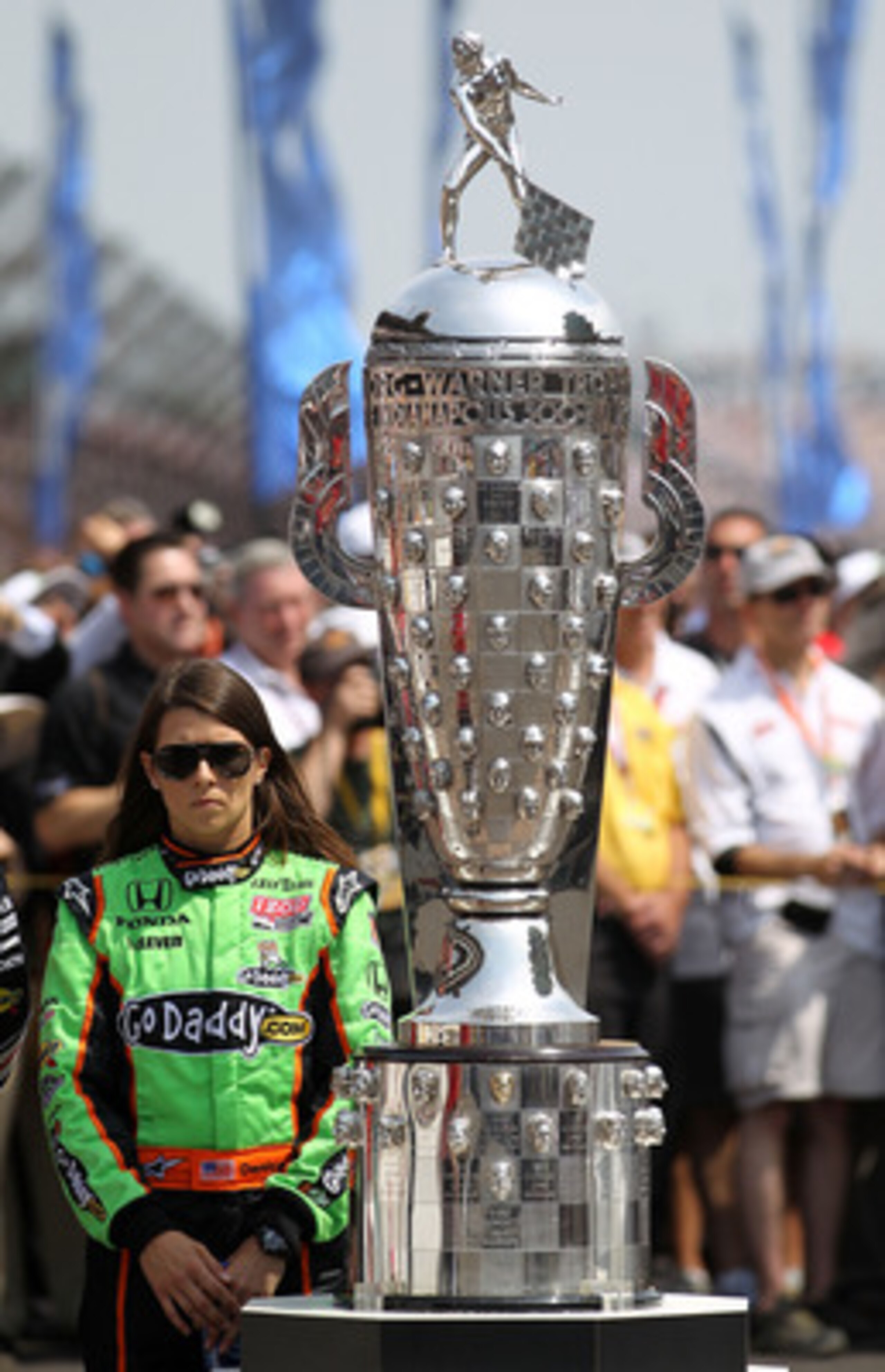 INDIANAPOLIS, IN - MAY 29:  Danica Patrick, driver of the #7 Team GoDaddy Dallara Honda, stands next to the Borg-Warner Trophy prior to the IZOD IndyCar Series Indianapolis 500 Mile Race at Indianapolis Motor Speedway on May 29, 2011 in Indianapolis, Indi