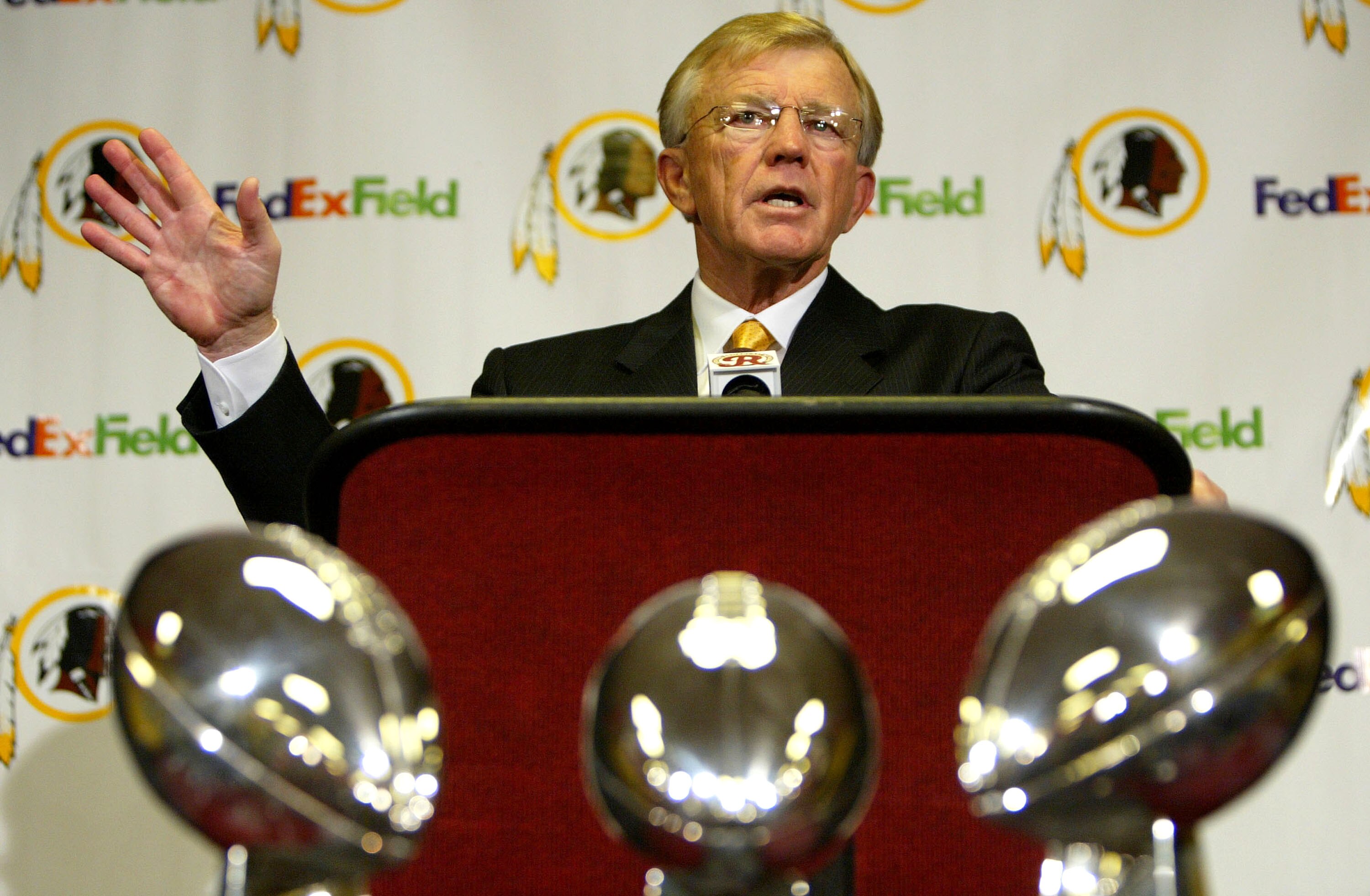 ASHBURN, VA - JANUARY 8:  Joe Gibbs addresses the media as he is announced as the new head coach of the Washington Redskins at a media conference on January 8, 2004 at Redskins Park in Ashburn, Virginia. The Redskins organizations' three Super Bowl Trophi