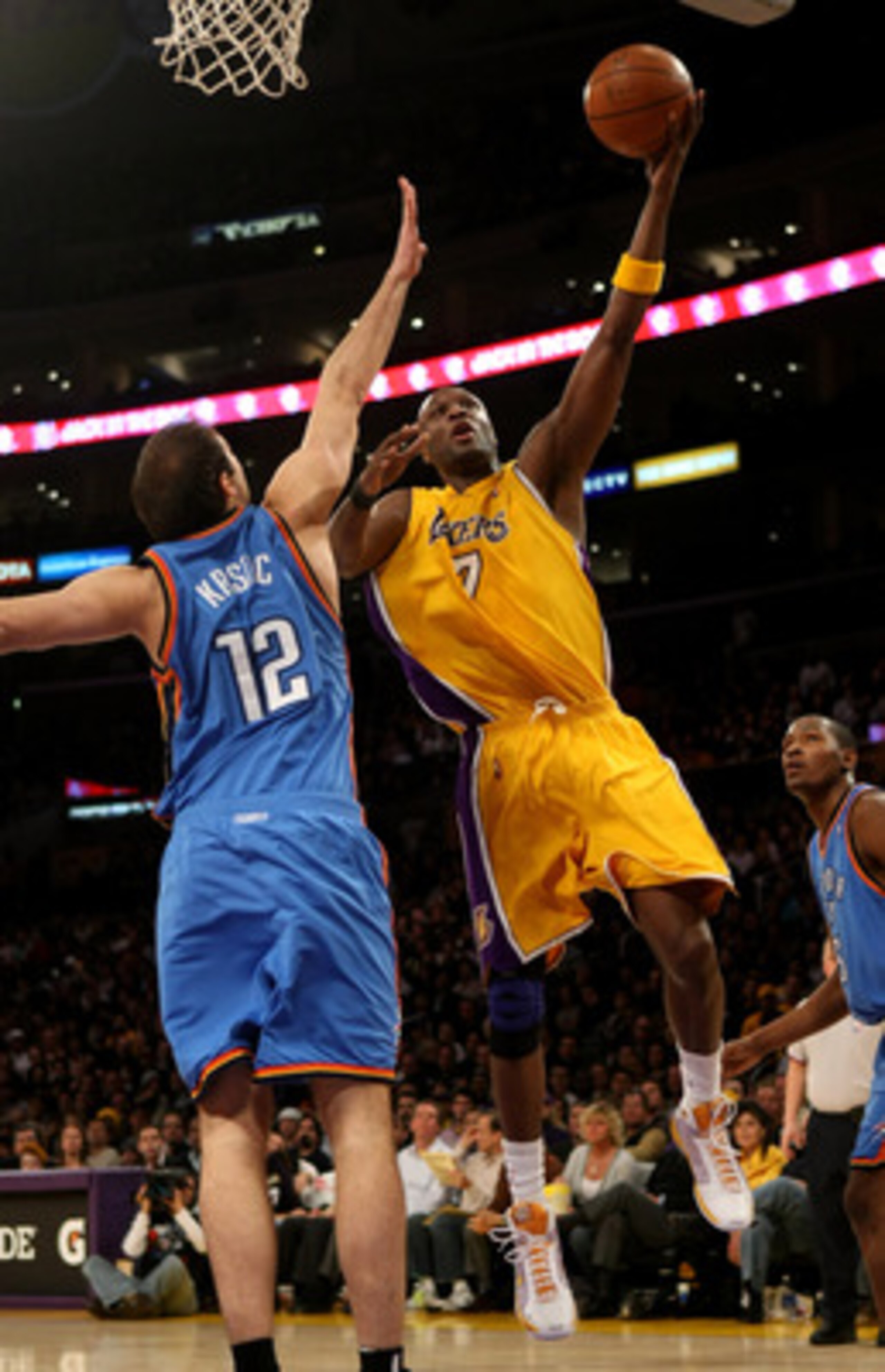 LOS ANGELES, CA - FEBRUARY 10:  Lamar Odom #7 of the Los Angeles Lakers shoots over Nenad Kristic #12 of the Oklahoma City Thunder on February 10, 2009 at Staples Center in Los Angeles, California.   NOTE TO USER: User expressly acknowledges and agrees th