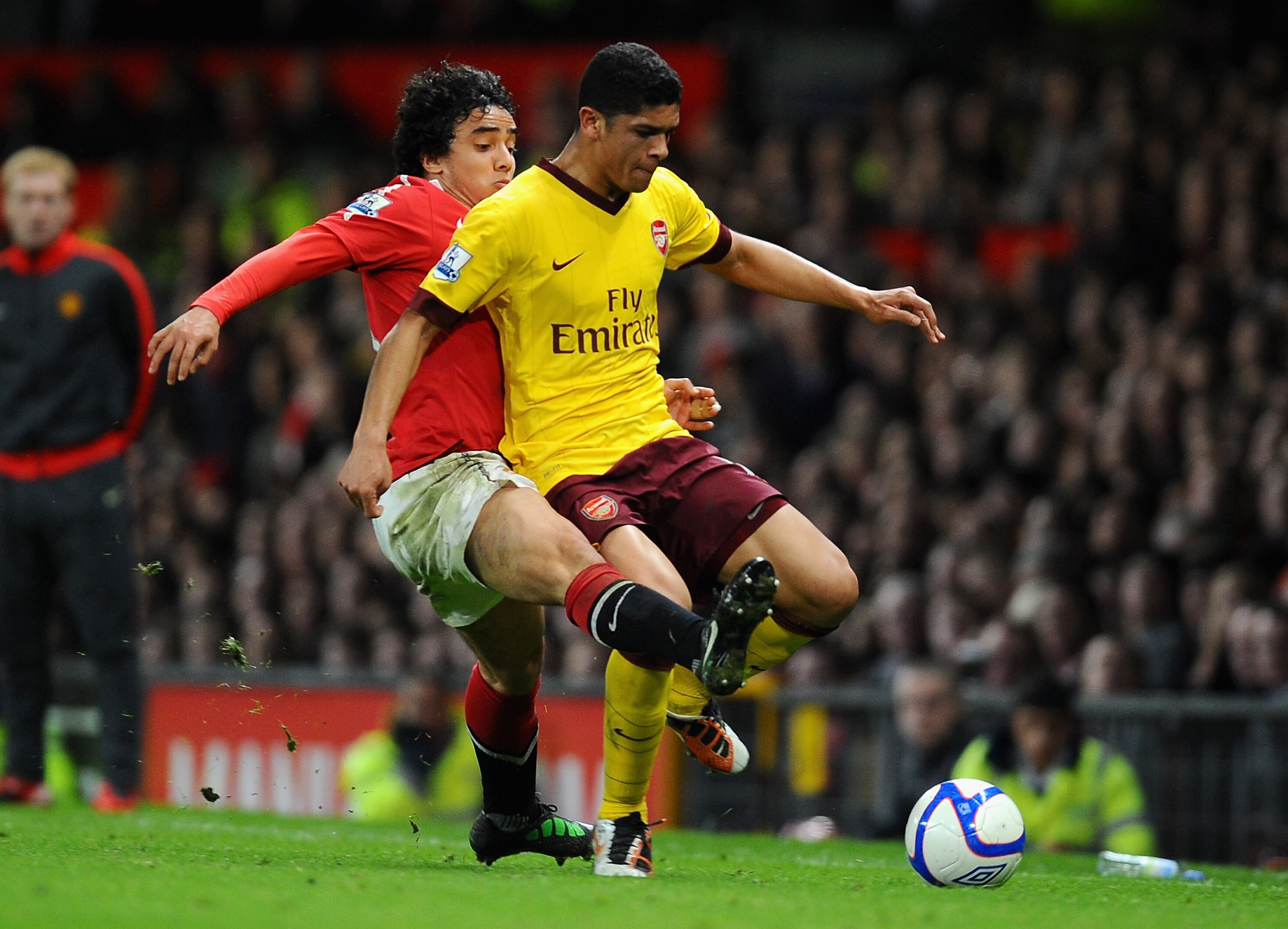 MANCHESTER, ENGLAND - MARCH 12: Rafael Da Silva of Manchester United and Denilson of Arsenal battle for the ball during the FA Cup sponsored by E.On Sixth Round match between Manchester United and Arsenal at Old Trafford on March 12, 2011 in Manchester, E MANCHESTER, ENGLAND - MARCH 12: Rafael Da Silva of Manchester United and Denilson of Arsenal battle for the ball during the FA Cup sponsored by E.On Sixth Round match between Manchester United and Arsenal at Old Trafford on March 12, 2011 in Manchester, E