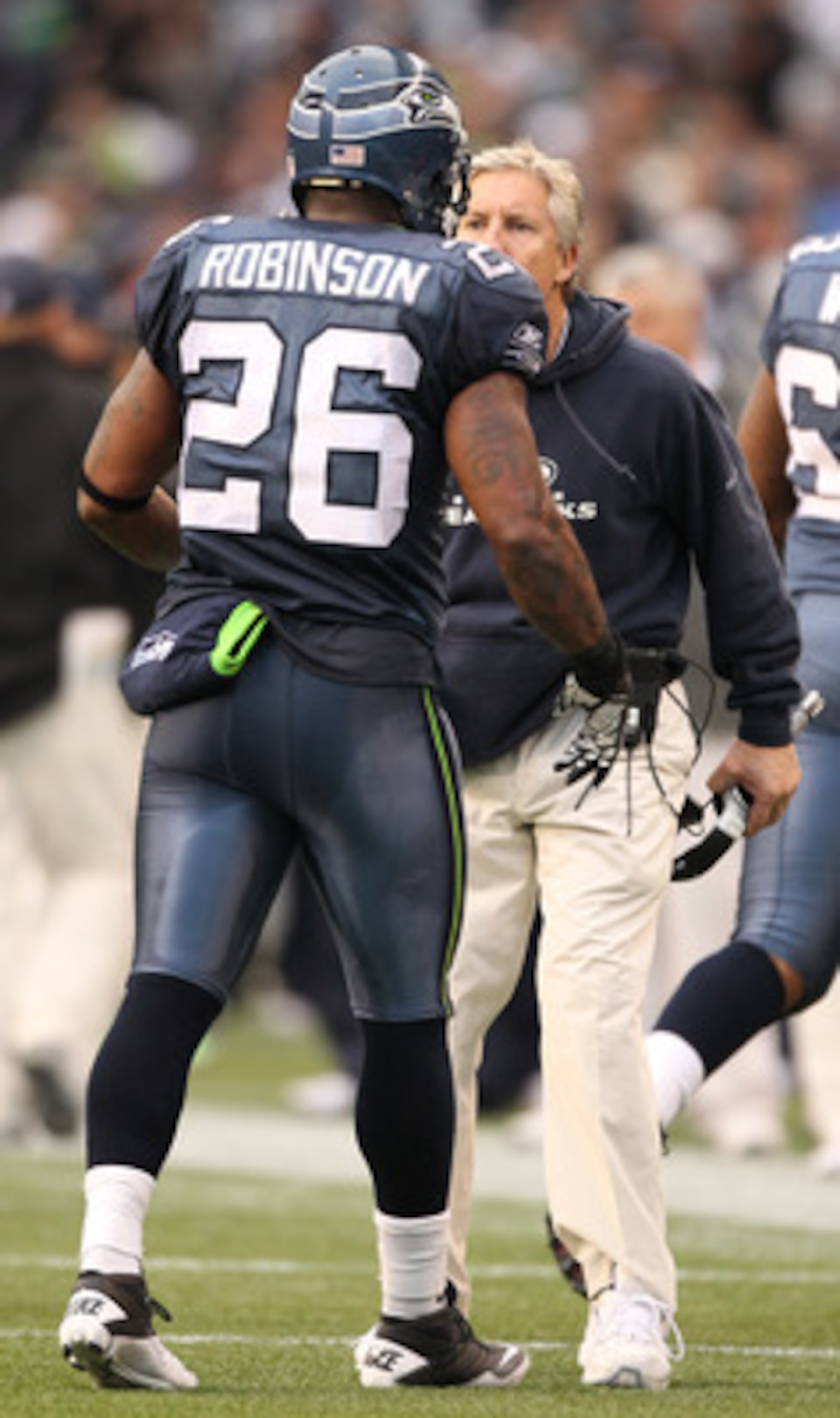 SEATTLE - DECEMBER 05: Head coach Pete Carroll of the Seattle Seahawks congratulates Michael Robinson #26 after Marshawn Lynch #24 scored a touchdown against the Carolina Panthers at Qwest Field on December 5, 2010 in Seattle, Washington. The Seahawks de SEATTLE - DECEMBER 05: Head coach Pete Carroll of the Seattle Seahawks congratulates Michael Robinson #26 after Marshawn Lynch #24 scored a touchdown against the Carolina Panthers at Qwest Field on December 5, 2010 in Seattle, Washington. The Seahawks de