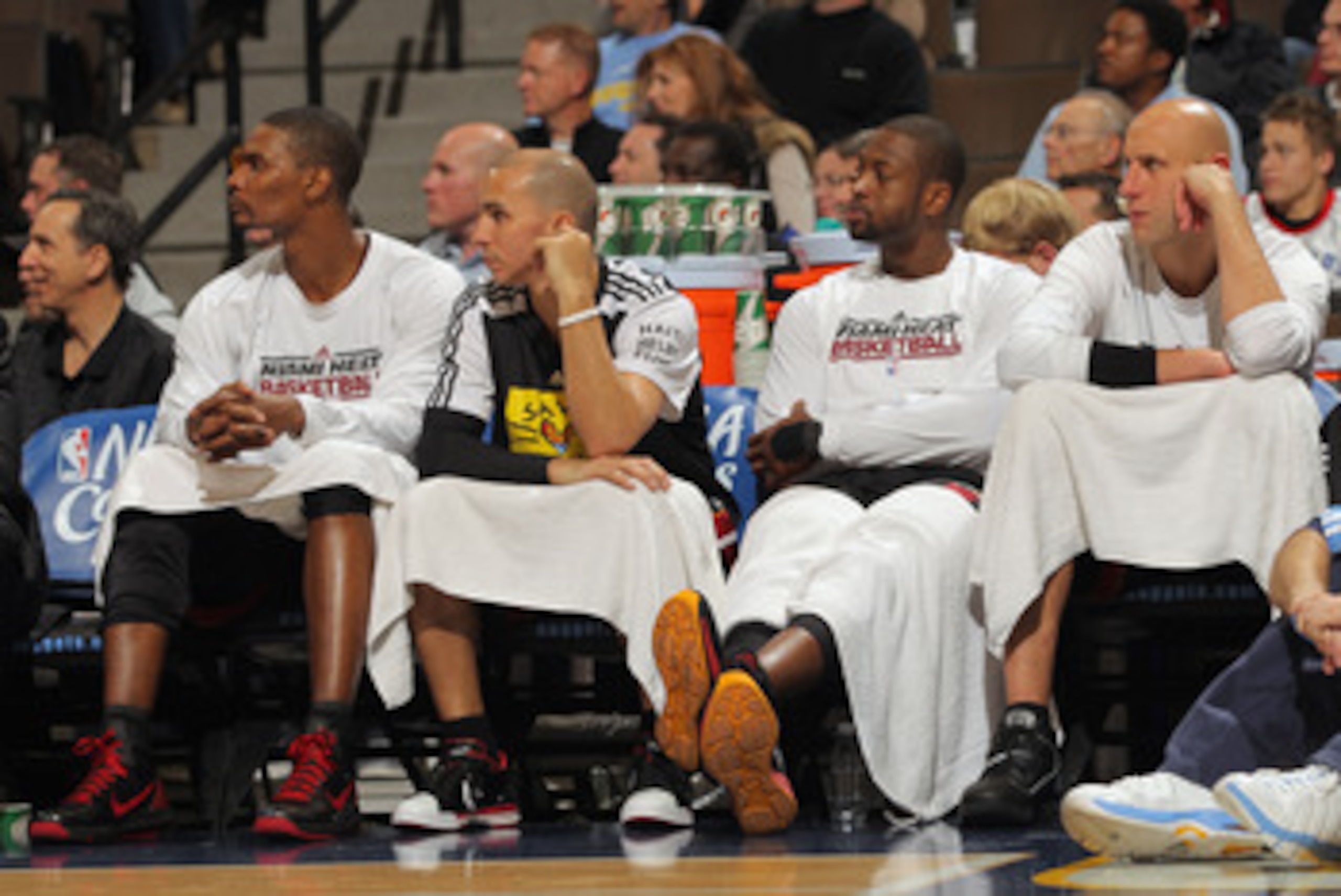 DENVER, CO - JANUARY 13:  (L-R) Chris Bosh #1, Carlos Arroyo #8, Dwayne Wade #3 and Zydrunas Ilgaukas #11 of the Miami Heat sit on the bench in the fourth quarter against the Denver Nuggets at the Pepsi Center on January 13, 2011 in Denver, Colorado. The 