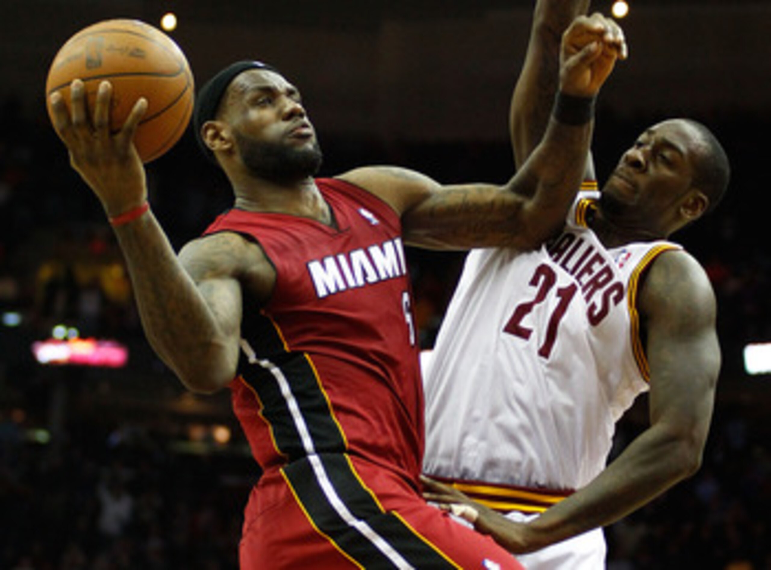 CLEVELAND - MARCH 29:  LeBron James #6 of the Miami Heat drives to the basket during the game against J. J. Hickson #21 of the Cleveland Cavaliers on March 29, 2011 at Quicken Loans Arena in Cleveland, Ohio. NOTE TO USER: User expressly acknowledges and a