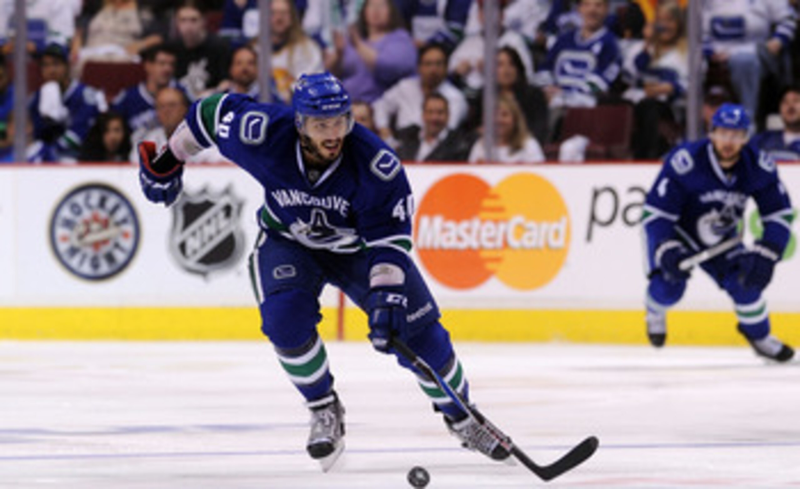 VANCOUVER, CANADA - MAY 24:  Maxim Lapierre #40 of the Vancouver Canucks skates the puck through the neutral zone in Game Five of the Western Conference Finals against the San Jose Sharks during the 2011 Stanley Cup Playoffs at Rogers Arena on May 24, 201