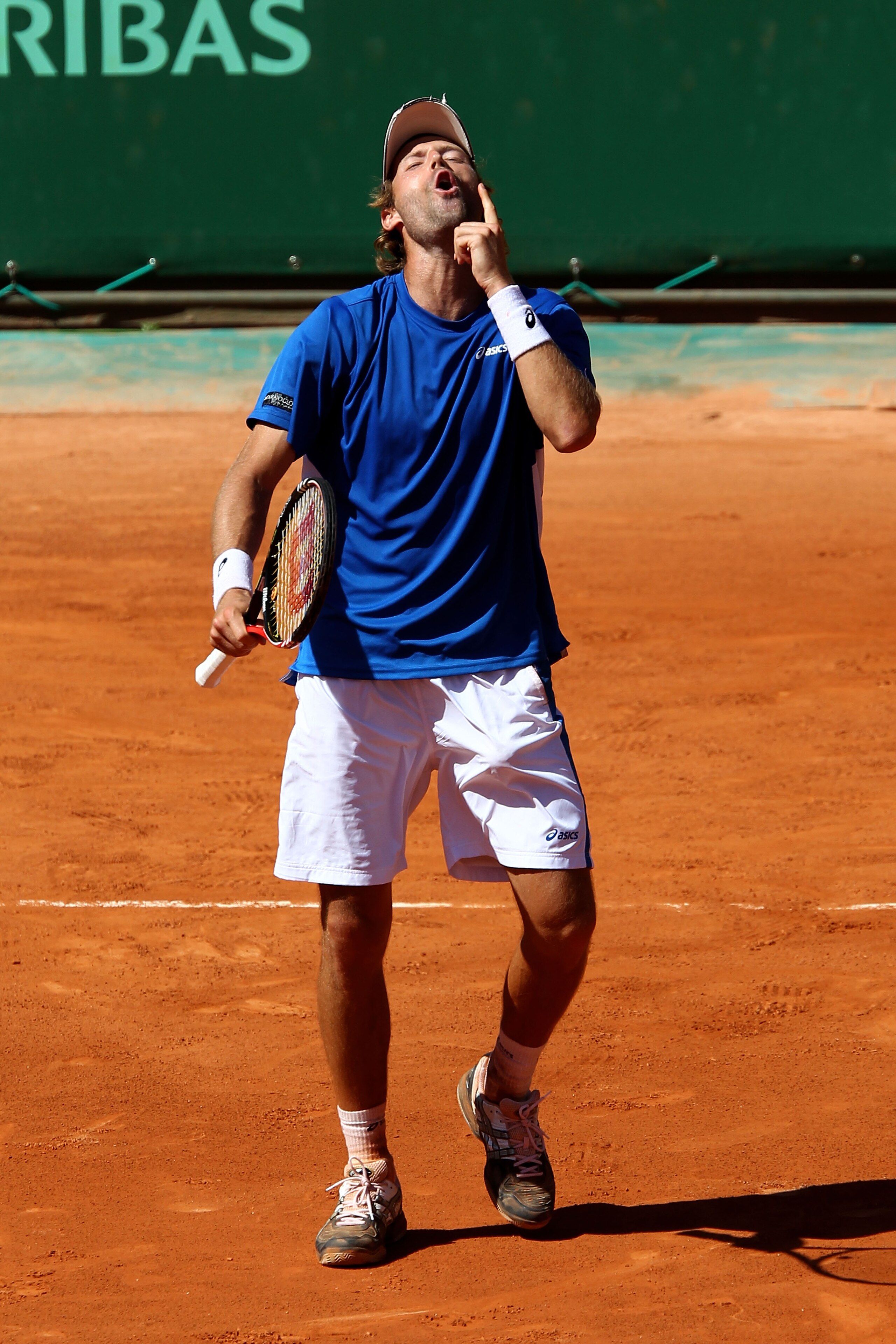 PARIS, FRANCE - MAY 23:  Stephane Robert of France celebrates match point during the men's singles first round match between Tomas Berdych of Czech Republic and Stephane Robert of France on day two of the French Open at Roland Garros on May 23, 2011 in Pa